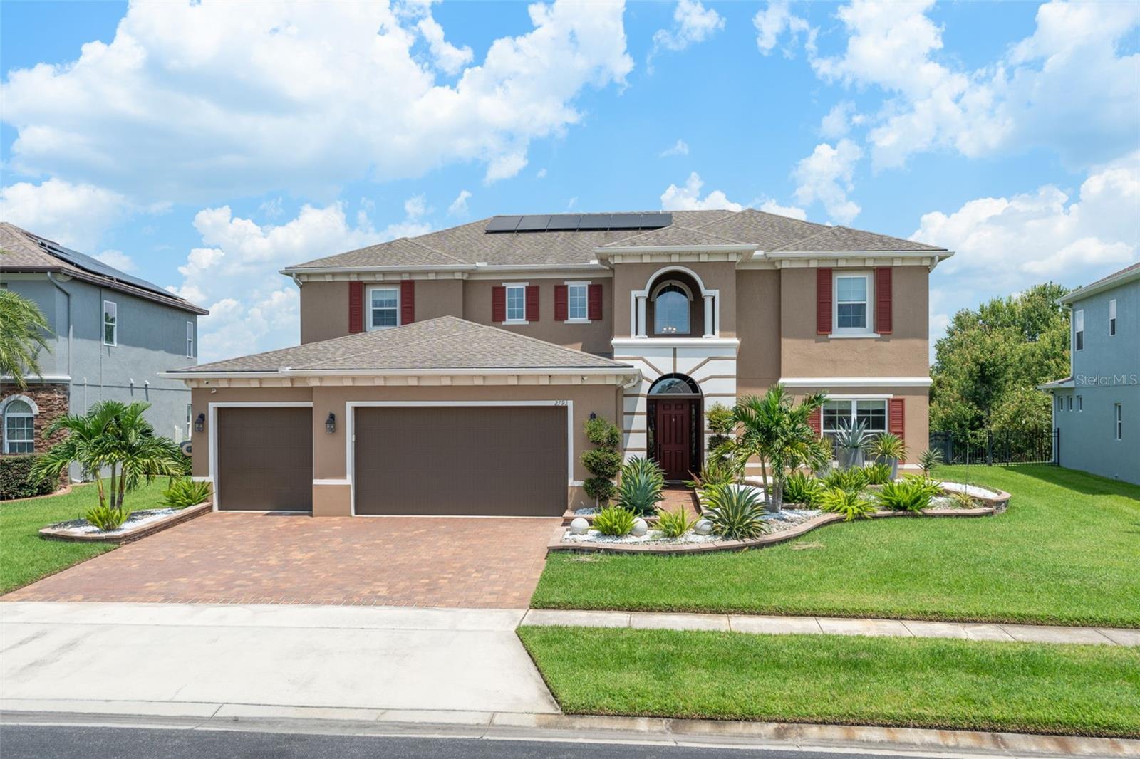 **This house comes with a REDUCED RATE through the seller's preferred lender. This is a lender-paid rate buydown that reduces the buyer's interest rate and monthly payment.** Welcome to this impressive nearly 4,000 sq ft residence tucked away on a tranquil half-acre lot in the sought-after Kissimmee area. With 4 spacious bedrooms, 3 full bathrooms, a 3-car garage, and a screened-in pool, this home is designed for both comfortable living and exceptional entertaining. From the moment you arrive, you're greeted by a beautifully manicured front yard with elegant paver walkways leading to a stately façade. The front entrance sets the tone with dual sidelites, an arched transom window, and a soaring second-story window that showcases the chandelier inside — a true statement of the grandeur that awaits. Step inside to the inviting family room, where natural light fills the space. To the right, discover a full guest bathroom conveniently situated between a well-sized guest bedroom and a versatile office space. Continue into the heart of the home and experience an open-concept layout connecting the kitchen, dining, and living areas. Accent walls add warmth and style, while French doors open to your private backyard oasis. The chef’s kitchen is a showstopper, featuring a large island with breakfast bar seating, stone countertops, rich dark cabinetry, stainless steel appliances, and a built-in double oven. Adjacent to the kitchen is a formal living room—perfect for entertaining—and easy access to the laundry room and garage. Upstairs, you’re welcomed by a spacious loft currently used as a home theater, complete with a projector and screen that convey with the home. To the left lies the luxurious primary suite, boasting a tray ceiling, stylish barn door, walk-in closet, and a spa-inspired ensuite with dual vanities, a centerpiece soaking tub, and a glass-enclosed walk-in shower. On the opposite side of the loft, you'll find two more generously-sized bedrooms with a full bath featuring a tub/shower combo and an extended vanity for extra space. Step outside into your private retreat. The expansive screened-in patio is ideal for al fresco dining, sunbathing, or simply lounging poolside. The resort-style pool features a tranquil stone waterfall, all set against the backdrop of a serene conservation area, offering peace and privacy with no rear neighbors. Additional features include fully paid-off solar panels, providing energy efficiency and long-term savings, and security cameras throughout the property that will convey with the home—offering peace of mind from day one. This home has it all — space, style, and serenity. Don’t miss your chance to own a piece of paradise at 2793 Autumn Breeze Way. Schedule your private showing today!