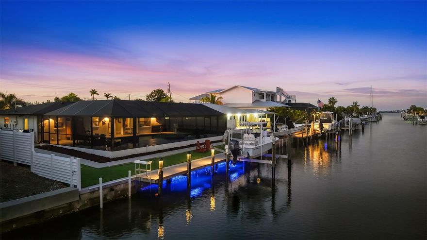 Meticulously renovated waterfront home with no HOA, offering turnkey Florida living with exceptional long-term value. This property did **NOT* flood and has undergone almost $500,000 in recent upgrades, including a NEW ARCHITECTURAL SHINGLE ROOF , fully remodeled resort-style pool and spa with all-new equipment, FULL REPLACEMENT OF THE SEWEGE DRAIN LINE, COMPLETE RE- PIPE of water supply lines, fresh INTERIOR and EXTERIOR PAINT, IMPACT RATED front and garage doors, new GUTTERS and downspouts, PVC fencing, and a 15,000-lb boat lift with new pilings and lighting. (Ask for flyer of All upgrades) .A new panoramic screen enclosure, remodeled pool deck with leathered marble pavers, modernized exterior lighting, and turf add to this outdoor transformation. Inside, the home features a fully remodeled kitchen and bathrooms, luxury vinyl plank flooring, custom closets, upgraded lighting, motorized shades, and designer finishes throughout—delivering a truly move-in-ready, low-maintenance residence that feels brand new. Direct access to inshore and offshore waters, this property is ideal for boating, fishing, full-time living, or short-term rental income. Ideally situated just two miles from Bradenton Beach and steps from the charming Cortez Fishing Village, with quick access to Anna Maria Island, Longboat Key, St. Armands Circle, and Lido Key. Furnishings and boat available for purchase separately.