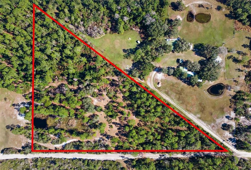 6.82 acres next door to 233 Azalea Ln. Pie shaped parcel with street address of NE corner of property. See pictures.
