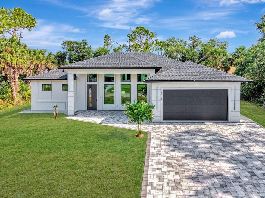 This CUSTOM HOME features every LUXURY feature you can imagine!!! As you pull into the paved driveway that was designed to fit three cars you will see the attention to every possible detail has been envisioned in designing this stunning property. The way the hurricane impact windows were designed to allow for natural light to the way the LED lights shine on the exterior. This sleek modern home has level 4 smooth finish on all the walls, adjustable LED lighting throughout, floor to ceiling tile in all the bathrooms, custom walk in closets in EVERY bedroom and 90" cabinets in the kitchen! The living room has a build in fireplace to elevate the mood, and the kitchen is every cooks dream.  It has Zline Autograph Addition Series appliances with gold features, pot filler, under cabinet lighting, no show cabinet in the Island and so much more!!!! The Primary bedroom has built in nightstands, massive walk in closets and you MUST SEE this primary bath! There is just too many details to describe the care and imagination it took to create something so special. Now for the laundry room, WOW!! This home is just a must see to understand the quality and attention to every single detail. The front door has a multi lock system, and the home comes with X Unified cameras all along the exterior. On the lanai there is pocket sliders, custom outdoor kitchen and bathroom which is great for entertaining.  NO detail has been missed in this stunning home!