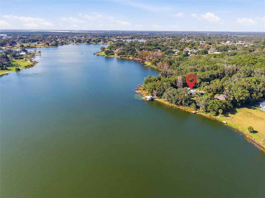 Welcome to a rare opportunity on sought-after spring-fed Lake Umatilla, where privacy, space, and waterfront living come together! Tucked away at the dead end of a quiet street, this stunning property sits on nearly one full acre of prime lakefront land (.93 acres) with an impressive 130 feet of shoreline, offering breathtaking views and endless possibilities.
This 4 bedroom, 3 bathroom home features a thoughtfully designed layout, including an attached in-law suite with its own private entrance that is perfect for multi-generational living, guests, or rental potential. Enjoy true Florida lake life with your private boat dock, plus the added bonus of an additional lot, providing exceptional future value and flexibility.
Outside, the property is a nature lover’s dream with mature fruit trees, expansive outdoor space, and ample bonus space thanks to a large detached 2-car garage, carport and large chicken coop. The enclosed back porch (2023) offers the perfect spot to relax and take in peaceful lake views year-round.
Major updates provide peace of mind, including a roof replaced in 2019, hot water heater replaced in 2022, brand-new AC in 2023, and fresh interior paint throughout in 2025. This home blends charm, functionality, and long-term investment potential in one of the area’s most desirable lakefront settings.
Lakefront properties like this don’t come along often! Schedule your private showing and experience Lake Umatilla living at its finest