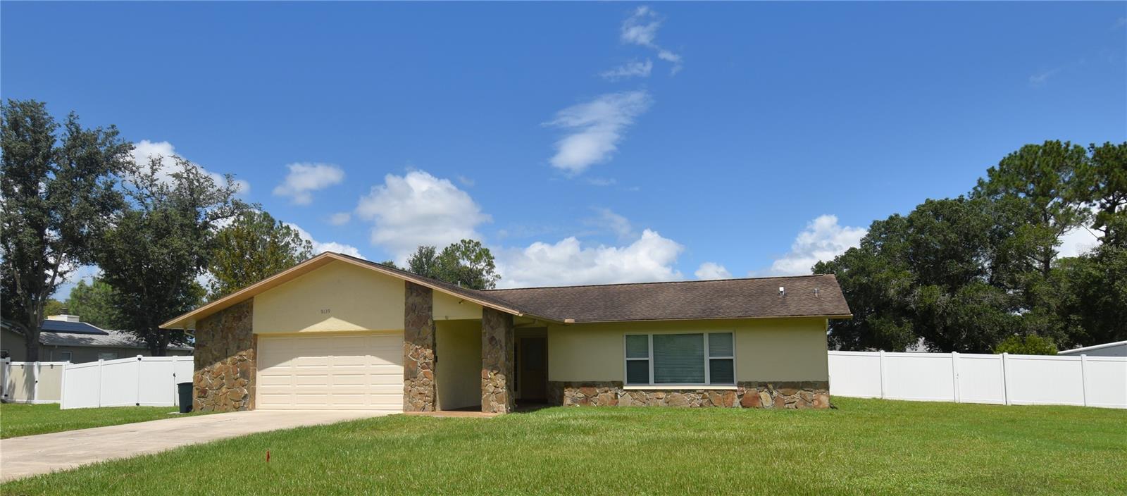 Charming 3-Bedroom Pool Home with no HOA and room for RV/Boat Parking in River Side Village! Welcome to this inviting 3-bedroom, 2-bath ranch-style home located in the sought-after River Side Village subdivision of New Port Richey. Offering ample space on a .58-acre lot, this well maintained pool home combines comfort, convenience, and the relaxed Florida lifestyle—without the burden of HOA fees.
Step inside to discover a spacious living room and dining room perfect for family gatherings and entertaining guests. The kitchen is designed for both functionality and style, with Corian countertops, a counter-height breakfast bar, and ample cabinetry for all your cooking essentials. Whether you’re preparing a family meal or hosting friends, this space will serve you well. Located right off the kitchen, the family room is equally impressive, featuring a cozy fireplace that adds warmth and charm. The ensuite master bedroom offers a walk in closet and full bath for your convenience. Two additional bedrooms and a second full bathroom provides plenty of room for family or guests. The home includes a separate laundry room with a utility sink and build in shelves. For your convenience, the LG washer and dryer are being included with the sale. You’ll love the enclosed Florida room. Providing an additional 350 square feet of living space not included in the home’s square footage, this versatile room is perfect for enjoying the sunshine year-round, entertaining guests, or creating your own personal retreat. Outdoor living takes center stage with an inground pool, ideal for cooling off during those hot summer months. With ample room for RV and boat parking, you'll have plenty of room for all your outdoor toys and hobbies. The vinyl privacy fence around the yard ensures peace and tranquility, while the oversized 2-car garage with an epoxy floor covering provides space for both vehicles and leaves you room for additional storage or your work bench. The home is located within the desirable River Side Village subdivision. Conveniently located off of Little Road, you’ll have easy access to local schools and shopping, including Longleaf Elementary and River Ridge Middle and High Schools. Whether you’re relaxing by the pool, hosting a barbecue, or enjoying the quiet surroundings, this property truly has it all. Don’t miss your chance to make this gem your new home. Schedule a showing today!