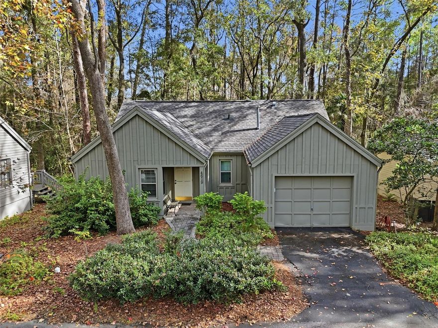 Nestled on a beautiful wooded lot in the Founders Hill neighborhood of Haile Plantation, this charming cottage-style home offers privacy, natural surroundings, and thoughtful updates throughout. Backing to a wooded conservation area, the setting provides a peaceful retreat.

This 2-bedroom, 2-bath home features 1,134 square feet of heated and cooled living space and 1,527 square feet under roof, including a single-car garage. The combined living and dining area features a high vaulted ceiling and a gas fireplace, creating an open and inviting living space. French doors in the living room open to an elevated wood deck overlooking the wooded conservation area behind the home.

The kitchen offers space for a café-style eating area and has been updated with wood cabinetry with soft-close features, along with a new stainless steel sink, faucet, garbage disposal, and refrigerator.

The primary bedroom includes a walk-in closet and an updated en-suite bath with a walk-in shower. The guest bedroom features a built-in Murphy bed system with a new mattress and sliding mirrored closet doors.

Flooring includes ceramic tile and new luxury vinyl plank — no carpet. 

Both bathrooms have been updated with new lighting, tall vanities, and toilets. The inside laundry room includes a washer and new dryer.

Additional improvements include a new natural gas water heater (July 2021), new HVAC system (February 2022), and new double-pane insulated windows installed in January 2023.

Ideally located approximately one mile from the Haile Village Center with shops, restaurants, and community events, and a short distance to Hawkstone Country Club, with membership options for golf, tennis, pickleball, pools, fitness classes, and dining. Haile Plantation also features scenic trails, Publix Market Square, and convenient access to UF, UF Health/Shands, HCA North Florida Hospital, Celebration Pointe, and Butler Plaza.