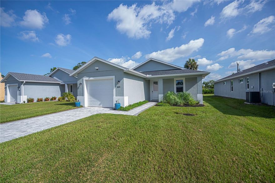 Step into this stunning 3-bedroom, 2-bath cottage-style home, built in 2022 and nestled in the highly desirable Venice Edgewood community of the charming City of Venice. Enjoy peace of mind in this nearly new residence, featuring an upgraded roof, AC, water heater, and impact-rated windows, doors, sliders, and garage door for added security and comfort. Inside, you’ll find tile flooring throughout,  two spacious guest bedrooms with a full guest bath, plus an expansive primary suite offering his and hers walk-in closets and a luxurious ensuite bathroom. The chef-inspired kitchen boasts elegant quartz countertops, a stylish tile backsplash, stainless steel appliances, premium shaker soft-close cabinetry, and a large island with seating for four to five—perfect for entertaining. The kitchen opens seamlessly to the inviting living and dining areas, all enhanced by soaring ceilings and a sought-after split floor plan ideal for fulltime or seasonal residents. Enjoy morning coffee outside on your covered patio overlooking the large backyard with plenty of room for a pool. Curb appeal abounds with a paver brick driveway and entryway, complemented by beautiful landscaping. With NO HOA, NO DEED RESTRICTIONS, and NO CDD fees, you’ll have ultimate flexibility. City of Venice sewer and water services add to your convenience. Enjoy an unbeatable location—just 2 miles from Venice Beach, 1 mile from historic downtown, steps from Mundy Park, and close to top-rated schools, including an A-rated Venice High School zone, shopping, dining, and medical facilities. This is the perfect blend of comfort, style, and location—schedule your showing today and make this exceptional home yours!