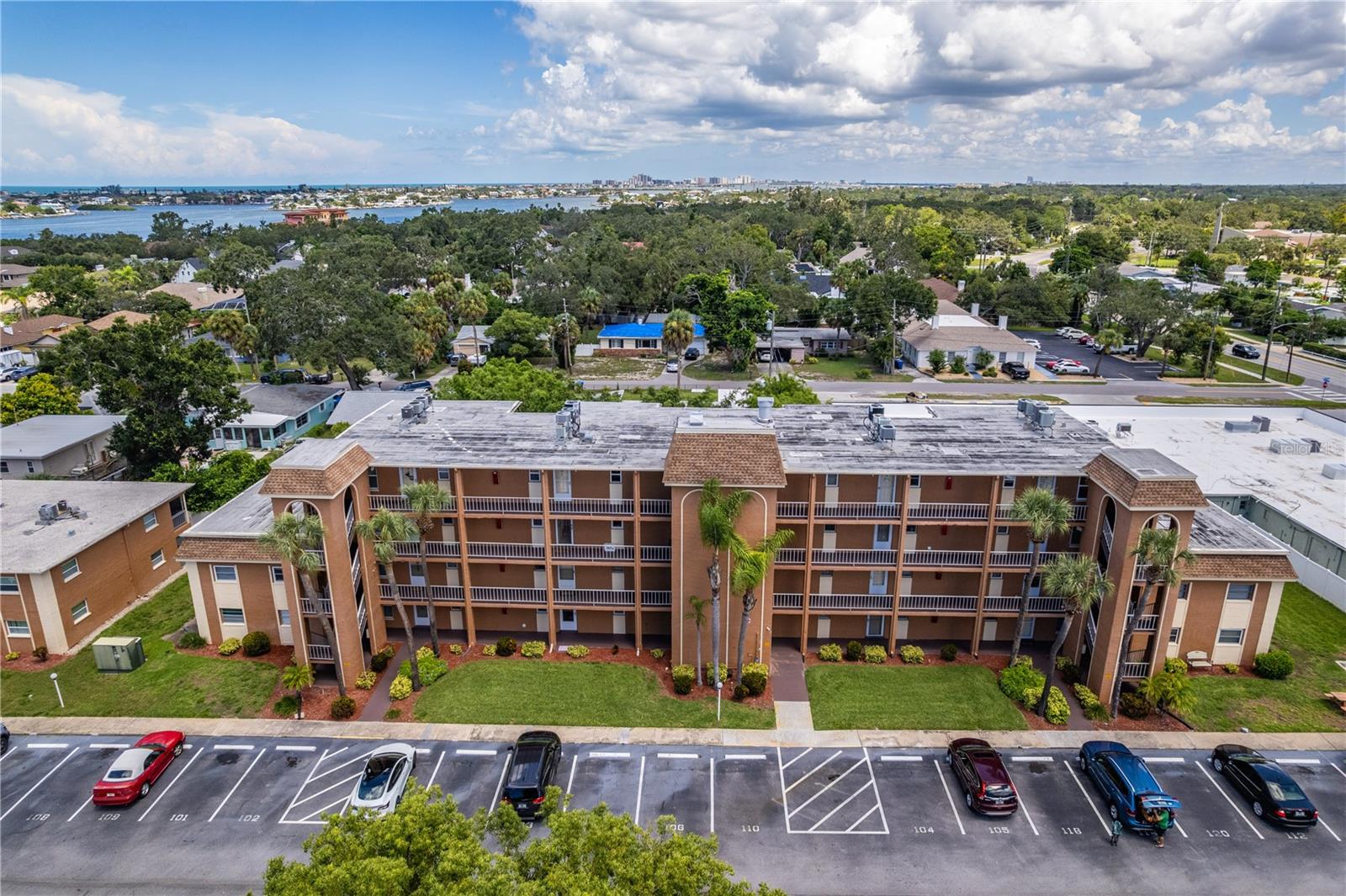 Live The Dream! Kick Back, Relax and Enjoy the Peaceful Serenity of Living in this Waterfront Resort Style Complex. Offering over 1,300 Sq. Ft with 2 Bedrooms, 2 baths,featuring a split floor plan for privacy,and plenty of room to entertain in the spacious living/dining rooms . New Hurricane Windows, along with the Slider Door both have Custom Cellular Shades,add a Full View Storm Door all together will provide an abundance of natural light , security and save on your energy costs. Experience carefree living with the easy care tile floors throughout, New A/C, Electric Panel and Water Heater all completed in 2021. The Kitchen has Updated Wood Cabinets,New GE Stainless Appliances,Beautiful Solid Surface Countertops with an Intergrated Sink all installed in 2024. Cooking will be a pleasure with updated lighting and a large closet pantry to hold plenty of groceries. Both Bathrooms (1 en suite, 1 jack and jill) have New Vanities featuring Solid Surface Tops and new Fixtures. Inside Laundry Room is a bonus with ample storage space. Enjoy sitting on your Private Balcony(with access from the primary bedroom and the living room ) having your morning coffee. You might never find a reason to leave with all the amenities offered: 2 sparkling,heated pools,a hot tub,fitness center, tennis and pickleball courts,shuffleboard,kayaking or maybe try a hand at fishing and grill your catch on 1 of the many bbq grills scattered around the complex. The grounds are lush with beautiful tropical flowers, plants and palm trees. There is a designated car wash area and a private gated access to Bonner Park. The large clubhouse has a full kitchen, pool table, other games and offers organized activities throughout the year. The location is hard to beat with restaurants, sports bars,shopping, drug stores, coffee shops, easy access to airports and most importantly our spectacular gulf beaches are nearby to walk, bike, or hop in the car. Dreams Do Come True. Paradise Awaits!