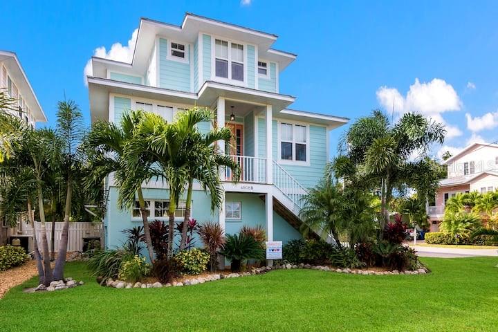 Beachside Luxury Rental – 3BR, 2.5BA with Pool
Live just steps from the sand at 4808 Gulf Drive Unit B, an upscale and fully furnished 3-bedroom, 2.5-bath home located in the heart of Holmes Beach. Available for starting July 19th, this multi-level coastal retreat blends modern comfort with laid-back island living—perfect for a long vacation or seasonal stay.
Step into a bright, open-concept living space with high ceilings, tile floors, and plenty of natural light. The spacious living room flows into a fully equipped kitchen featuring granite countertops, stainless steel appliances, and a breakfast bar—ideal for casual meals or entertaining.
Upstairs, the private master suite spans the top level with a king-size bed, cozy sitting area, workspace, and its own balcony—perfect for morning coffee or unwinding at sunset. The en-suite bathroom includes a walk-in shower and soaking tub for spa-like relaxation.
Two additional bedrooms—one queen, one twin—are located on the second level and share a full bath. A separate half-bath and in-unit laundry provide added convenience.
Outside, the private heated pool is surrounded by tropical landscaping, offering a serene escape with lounge chairs, a covered patio, outdoor dining space, and grill. Bonus features include an elevator, two-car garage, and a fun game area with a foosball table.
Located just a short stroll from the Gulf of Mexico (no busy streets to cross), and close to shops, restaurants, and the island trolley line—this home delivers the ultimate in Anna Maria Island living.
Available July 19 – inquire now to lock in your slice of beachside paradise!