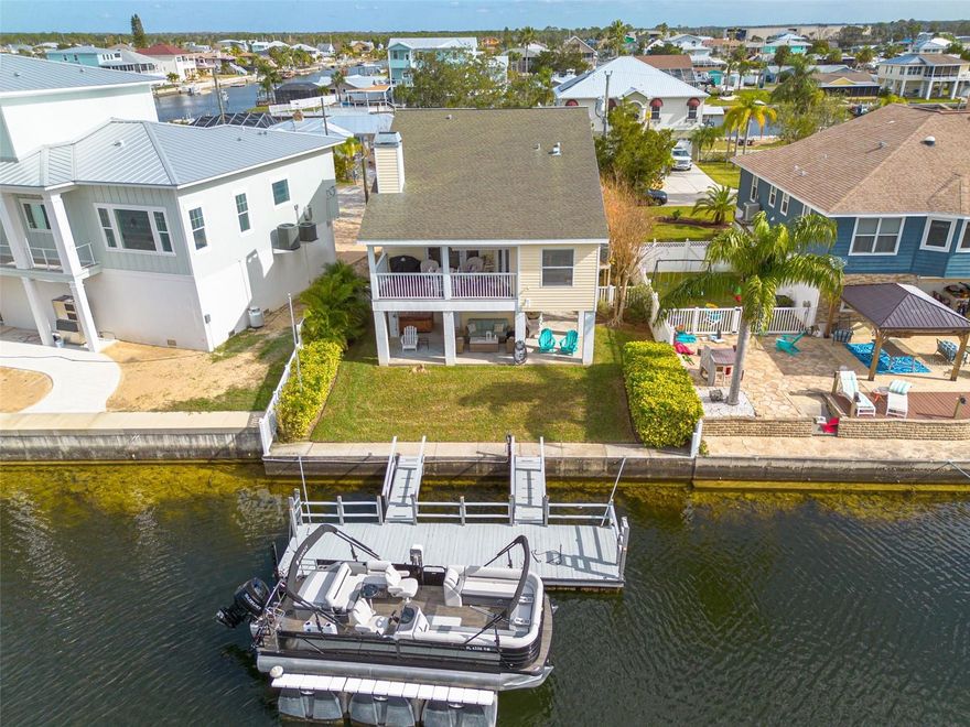 Welcome to your coastal dream home in Hernando Beach, Florida, where modern luxury and the tranquil Gulf Coast lifestyle converge! This stunning ELEVATED 3-story stilt home includes 3 bedrooms, 2.5 bathrooms, and 50 feet of prime waterfront on the Robin Canal, one of the largest and deepest saltwater canals in the area. A new dock (2024) with direct Gulf access and no fixed bridges is a boater’s paradise that promises endless adventures on the water. This is a true, just bring-your-toothbrush, move-in ready home. Step inside and be amazed by the airy layout, elevated ceilings, and bountiful natural light that make every corner of this home feel bright and welcoming. The recently remodeled kitchen—with more than $40,000 invested in enhancements—is a food enthusiast’s haven, showcasing quartz countertops, a
farmhouse sink, white shaker cabinets, and generous space for both meal prep and socializing. Flowing effortlessly into the main living area, the kitchen sets the stage for gatherings of any size. You’ll love the gorgeous wood flooring underfoot and the dramatic stone fireplace, which lend a cozy yet refined vibe. Soak in expansive water views from both the kitchen and living room, perfect for entertaining or simply relishing the calming scenery. Step out onto the covered balcony to sip your coffee as sunlight shimmers on the canal or settle in with a glass of wine while taking in the mesmerizing sunsets. On the main floor, you’ll also find two spacious guest bedrooms with sizeable closets, a full bath, a half bath for added convenience, and a dedicated laundry room. Ascend to the top floor to discover your own private escape: the primary suite featuring a generously sized bedroom, a walk-in closet, and a luxurious en-suite bathroom with a large step-in shower. An adorable loft lies adjacent to the suite, while a private balcony offers sweeping views of the canal and nearby coastal properties. Outdoor living is equally captivating. A covered back patio invites you to lounge in the shade, a private floating wood dock makes fishing or boating a breeze, and a hot tub promises ultimate relaxation after a day on the water. With a 50-foot seawall, you’ll enjoy direct access to the canal—perfect for storing watercraft, casting a line, or watching dolphins and manatees swim by. Best of all, no HOA fees or restrictions mean you can fully embrace the waterfront lifestyle, whether you’re parking boats or trailers onsite or exploring SHORT-TERM RENTAL opportunities. Situated at the end of a cul-de-sac, this home places you within walking distance of two marinas and several of Hernando Beach’s top eateries, including Brian’s Place, Hernando Beach Tropical Grille, and the Silver Dolphin. Local gems like Rogers Park, Pine Island, and Weeki Wachee Springs State Park are just a short drive away to Homosassa, Aripeka, Clearwater, and Tarpon Springs. Offered fully furnished (minus a few personal and patio items), this turnkey property lets you transition seamlessly into a coastal lifestyle. Whether your heart yearns for tranquil mornings, Gulf Coast excursions, or the friendly ambiance of Hernando Beach, this inviting retreat delivers it all. Don’t miss out on your chance to claim this waterfront haven—begin your Paradise Life today! Don't forget to check out the 360-degree walk through link!