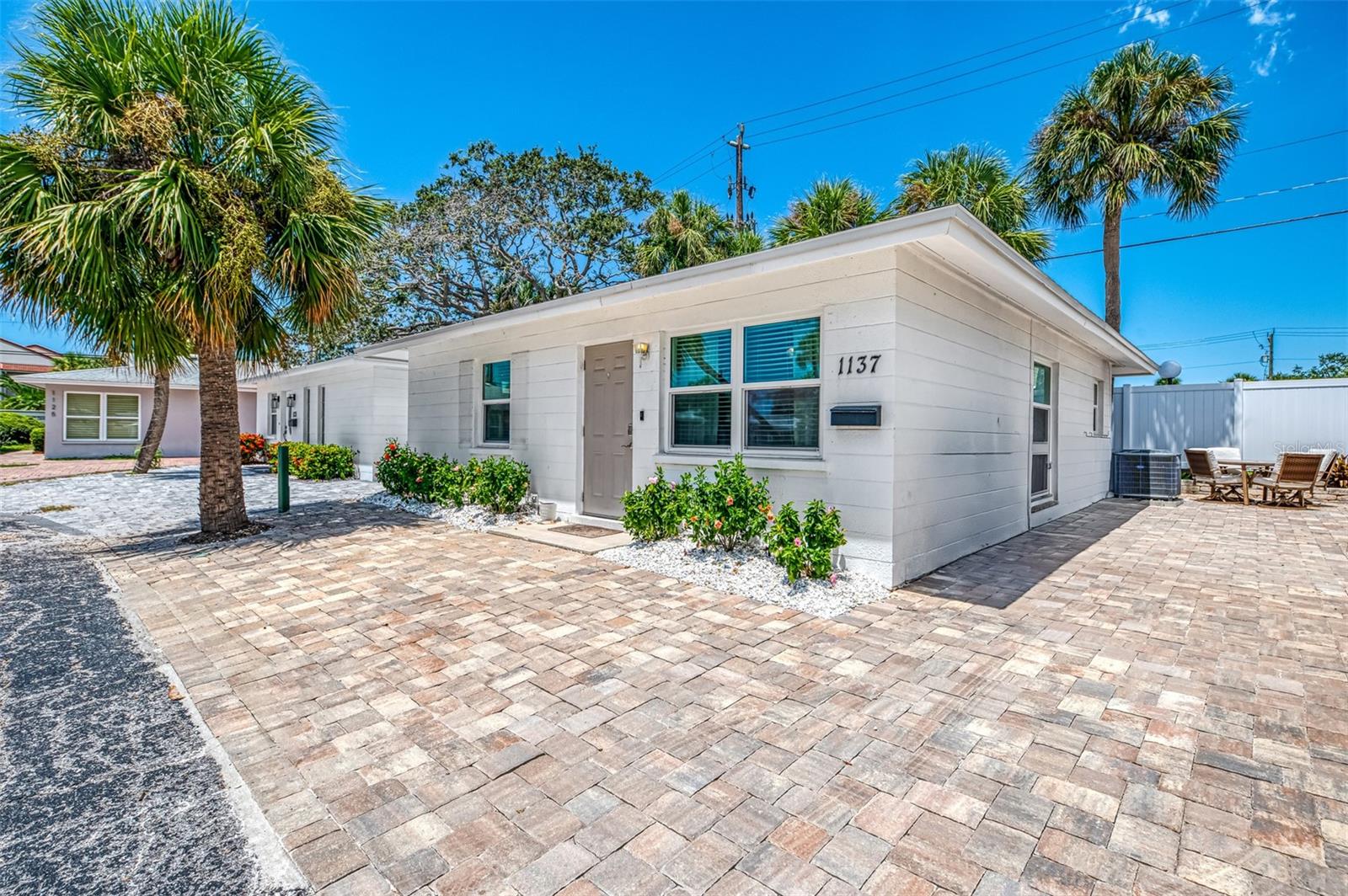 This is a short term rental. Listing reflects peak season rate. Available peak season months: January 2026, February 2026, April 2026. Welcome to The Blue Luna, a serene stand-alone villa nestled in the tropical paradise of Polynesian Gardens on Siesta Key. This two-bedroom, two-bathroom home has been thoughtfully decorated with a calming, coastal blue palette that reflects the soft light of the moon on the water. The spacious living area is bathed in natural light, inviting you to relax and unwind. The primary bedroom features a king-size bed and an elegant ensuite bathroom, offering a private haven for rest. The second bedroom, with its twin-size and double-size bed, is perfect for families or friends ready for a peaceful retreat. Start your day by watching dolphins play in the water as the sun rises, then take a refreshing dip in the nearby heated pool. For a more adventurous afternoon, cast a line from the community fishing pier for the catch of the day. As evening approaches, prepare to be enchanted by the breathtaking Siesta Key sunsets and the rhythmic sounds of the local drum circle celebration—a truly magical tradition. Located near vibrant restaurants, bars, and attractions, you'll find plenty to do without ever needing a car. At The Blue Luna, you can relish the stunning sunsets, lose yourself in the rhythmic beat of the drum circle, or simply enjoy a quiet moment by the pool. Book your stay today and claim your slice of paradise where the magic of the moon meets the tranquility of the sea.