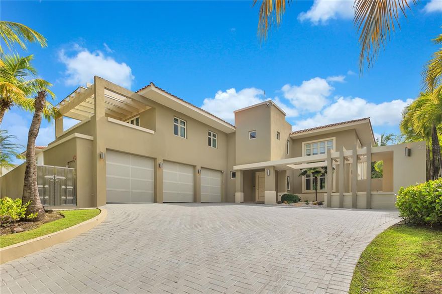 Welcome to an unparalleled luxury oasis in the Dorado Beach Ritz Carlton Reserve, nestled within the coveted Dorado Beach East community. This magnificent residence boasts an impressive total area of 6,330 square feet, with 4,687 square feet of exquisite living space, representing a sublime fusion of contemporary design and tropical architecture, creating a sanctuary of elegance, privacy, and absolute comfort.**

As you cross the threshold, a luminous and inviting atmosphere envelops you through an open design, where large windows, meticulously positioned, flood each corner with natural light. The foyer gracefully flows into expansive living areas, where sophistication harmonizes with a relaxing ambiance. Each space is crafted with clean lines and a modern aesthetic, accentuated by a sense of openness that draws the eye toward the stunning exteriors.

To your left, an elegant game room emerges as the ideal space for entertaining distinguished guests or cherishing memorable moments with family. Progressing further, the generous, state-of-the-art kitchen reveals a world of culinary possibilities, equipped with top-of-the-line appliances and ample storage, making it a chef’s dream. Adjacent to it, a private lounge offers an exclusive retreat for self-care and relaxation, complemented by a cutting-edge gym designed to satisfy even the most discerning fitness enthusiasts.

The residence features four luxurious bedrooms, each with its own en-suite bathroom, where the master suite stands out as a personal sanctuary. This retreat boasts a contemporary bathroom showcasing high-end finishes and fixtures, ensuring maximum privacy and transforming every moment into an experience of pure indulgence.

Stepping outside, you will find two private balconies offering serene views of the lush tropical landscape, creating a perfect setting for contemplation. The outdoor spaces are designed for maximum sophistication and enjoyment, with a private pool serving as the focal point of the backyard, inviting you to cool off or simply relax in an idyllic environment. A fully equipped bar and grill area elevate the outdoor experience, ideal for intimate dinners, elegant barbecues, or social gatherings. This area seamlessly integrates indoor and outdoor living, becoming the perfect stage for daytime leisure and evening entertainment.

Security is paramount in this residence, equipped with state-of-the-art surveillance cameras and 24/7 security, ensuring the tranquility and privacy of its inhabitants. Additionally, it features a spacious three-car garage, providing generous parking and storage space, along with essential utilities such as a water cistern and a power generator, guara

What sets the Dorado Beach East community apart within the Dorado Beach Resort is its unparalleled exclusivity. Residents enjoy the club featuring a pool, tennis courts, a soccer field, and even an aviation-themed family park on a historic airstrip, which includes a basketball court and a custom water park. Moreover, the residence is surrounded by the island's most golf courses, offering golf enthusiasts privileged access to world-class greens, all in an environment where every detail is designed for the enjoyment of a and, discerning community.