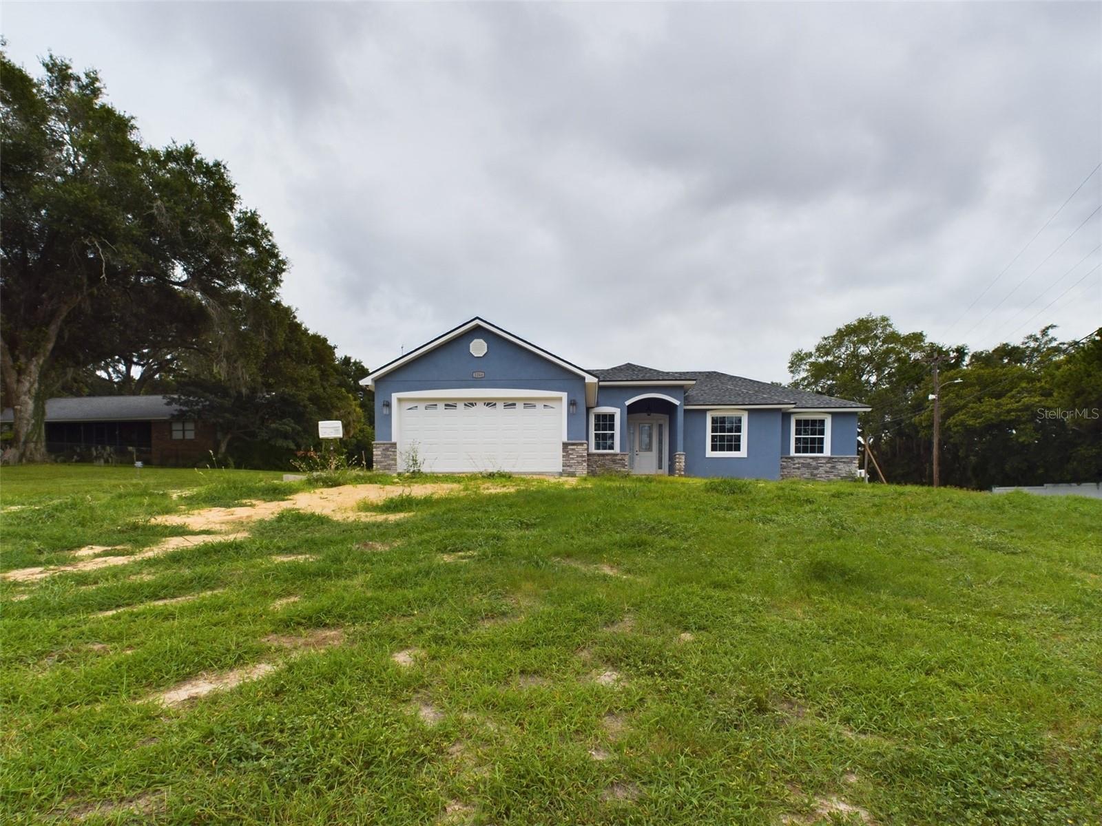 LAKEFRONT! NO HOA! NEW CONSTRUCTION! Welcome to 1264 Lake Buckeye Rd in Winter Haven, a beautiful, never-before-lived-in home home offering 2,675 sq. ft. under roof and packed with modern features. WOW! OVER 0.44+ ACRES OF OWNED LAND on a spacious corner lot. Enjoy the Florida lifestyle with a screened lanai, beautifully landscaped yard, and direct lakefront access to Lake Buckeye for fishing, kayaking, or relaxing by the water. A brand new private boat dock is currently being built and will be fully functional before closing—calling all fishermen and boating enthusiasts—this is your dream setup! Located near Polk State College, this spacious home features a desirable split floor plan with 4 bedrooms, 2.5 bathrooms, a dedicated dining room, and an attached 2-car garage. Step inside to find granite countertops throughout, upgraded tile showers, a luxurious garden tub, and updated LED lighting for a bright and modern feel. The kitchen is equipped with stainless steel appliances, solid surface granite counters, a standalone kitchen island, and plenty of cabinet space—ideal for both daily living and entertaining. The home also features vinyl plank flooring throughout, 9'4" flat ceilings, and recessed can lighting for a sleek and open atmosphere. The indoor laundry room includes washer and dryer hook-up, and the garage boasts a durable epoxy-coated floor. For added peace of mind, the home includes a security system and a video doorbell camera. Short- and long-term rentals are allowed with no leasing restrictions—a perfect investment for Airbnb potential, or an ideal opportunity for first-time homebuyers seeking lakefront living with no HOA. Seller financing and private financing available. Contact us for more details! Don’t miss out—schedule your private showing today before this rare lakefront gem is gone! Do NOT wait, it will not last long!