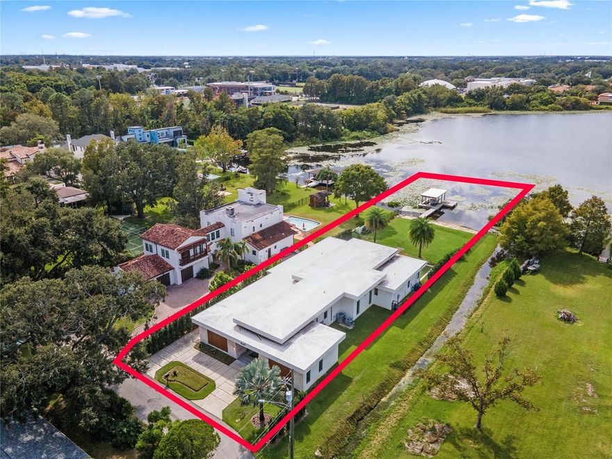 Welcome to 849 Post Lane, where modern luxury meets sophistication in the heart of Orlando. This exceptional, skiable lake front, 2020 built home boasts an unparalleled fusion of sleek design and state-of-the-art amenities, setting a new standard for contemporary living. Step inside this architectural masterpiece and be greeted by a grand foyer that seamlessly flows into expansive living spaces illuminated by natural light cascading through large windows. The open-concept layout is perfect for entertaining, with a chef's kitchen that is a culinary dream come true. Complete with top of the line appliances including a sleek induction stove, commercial-sized Thermador appliances, and a butler's pantry, the kitchen also features a one-of-a-kind Panda Marble waterfall edge countertop that adds a touch of elegance to the space. Luxuriate in the spacious master suite, complete with a spa-like ensuite bathroom featuring dual vanities, a soaking tub, and a walk-in shower. Additional bedrooms, including a second master bedroom with en-suite bath, offer ample space and comfort, ensuring privacy and relaxation for all residents. Designed with the utmost attention to detail, this home is adorned with premium finishes and fixtures, including brushed oak floors, designer lighting, and contemporary accents throughout. The study can also be used as a bedroom. Experience outdoor living at its finest in the meticulously landscaped backyard oasis, where you can unwind on the expansive patio or gather around the fire pit under the stars. For the car enthusiast, your new home features a double car garage and a covered motor court that can comfortably fit 3 more cars. Conveniently located in a central Winter Park/Orlando area, this residence offers easy access to renowned dining, shopping, entertainment, and top-rated schools. Don't miss your opportunity to own this extraordinary modern masterpiece at 849 Post Lane. Schedule your private showing today and elevate your lifestyle to new heights.