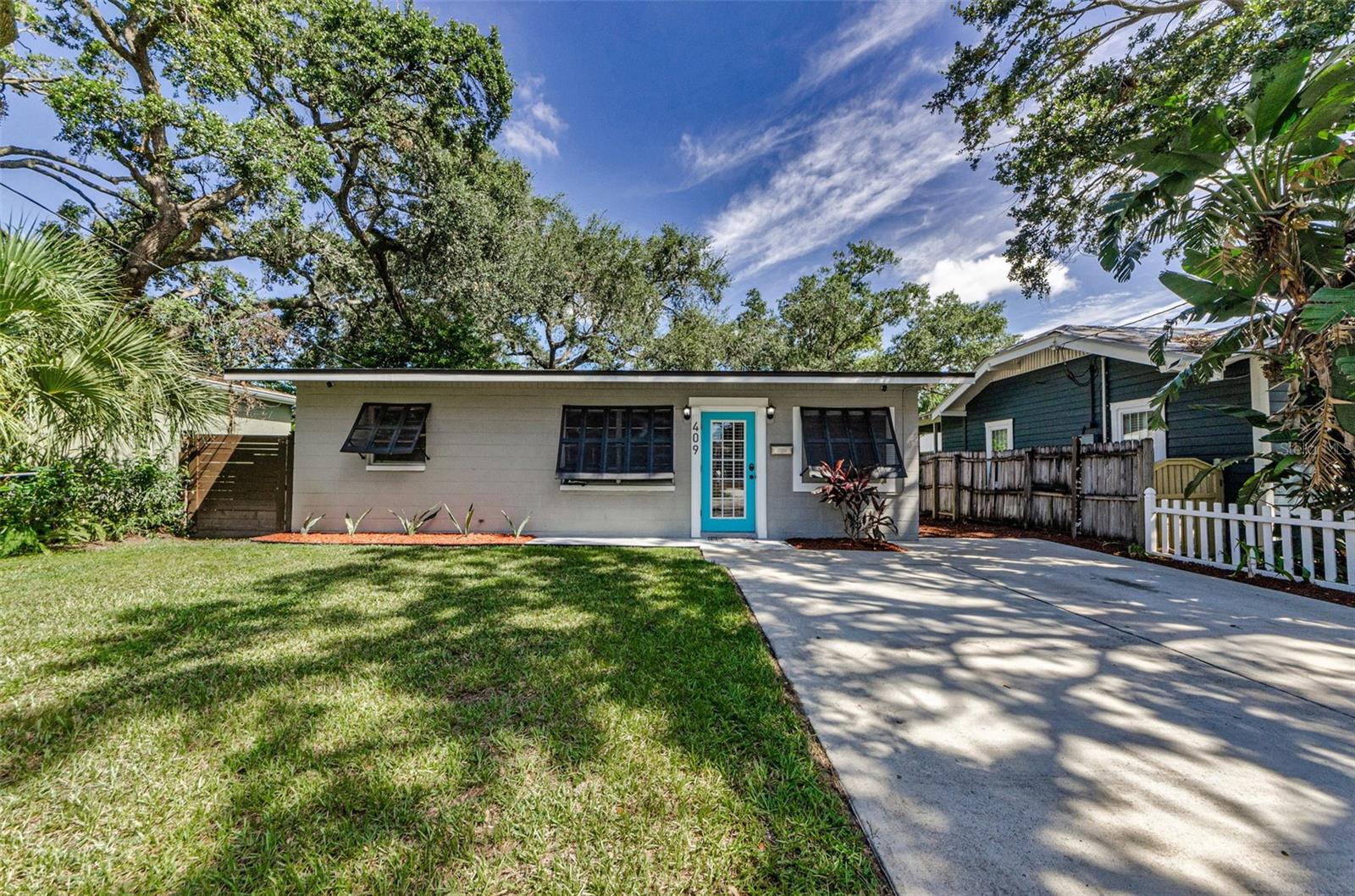 Welcome to 409 W Hanna Ave, a delightful block construction bungalow that perfectly blends character and convenience. This 2-bedroom, 1-bath home sits on a deep, beautifully landscaped lot with plenty of space to relax and entertain.
Step inside to find a light and bright interior featuring tile flooring throughout (no carpet!), wood cabinetry, and thoughtful updates that make the home move-in ready. The open floor plan creates a warm and inviting atmosphere, while large windows fill the space with natural light.
Enjoy stunning curb appeal with fresh landscaping and a welcoming turquoise front door that sets the tone for this charming home. The spacious backyard is designed for fun and functionality, offering an open patio perfect for grilling, a storage shed, and even your own putting green.
Major updates provide peace of mind, including a newer Roof (2022), HVAC (2018), and Water Heater (2018).
Located just blocks from the Hillsborough River, public boat ramps, scenic parks, dog parks, and a vibrant mix of restaurants and breweries, this home places you in the heart of the highly sought-after Seminole Heights area. Plus, with quick access to the interstate and downtown Tampa, commuting is a breeze.
Don’t miss the opportunity to own this charming bungalow with modern updates and a fantastic location!