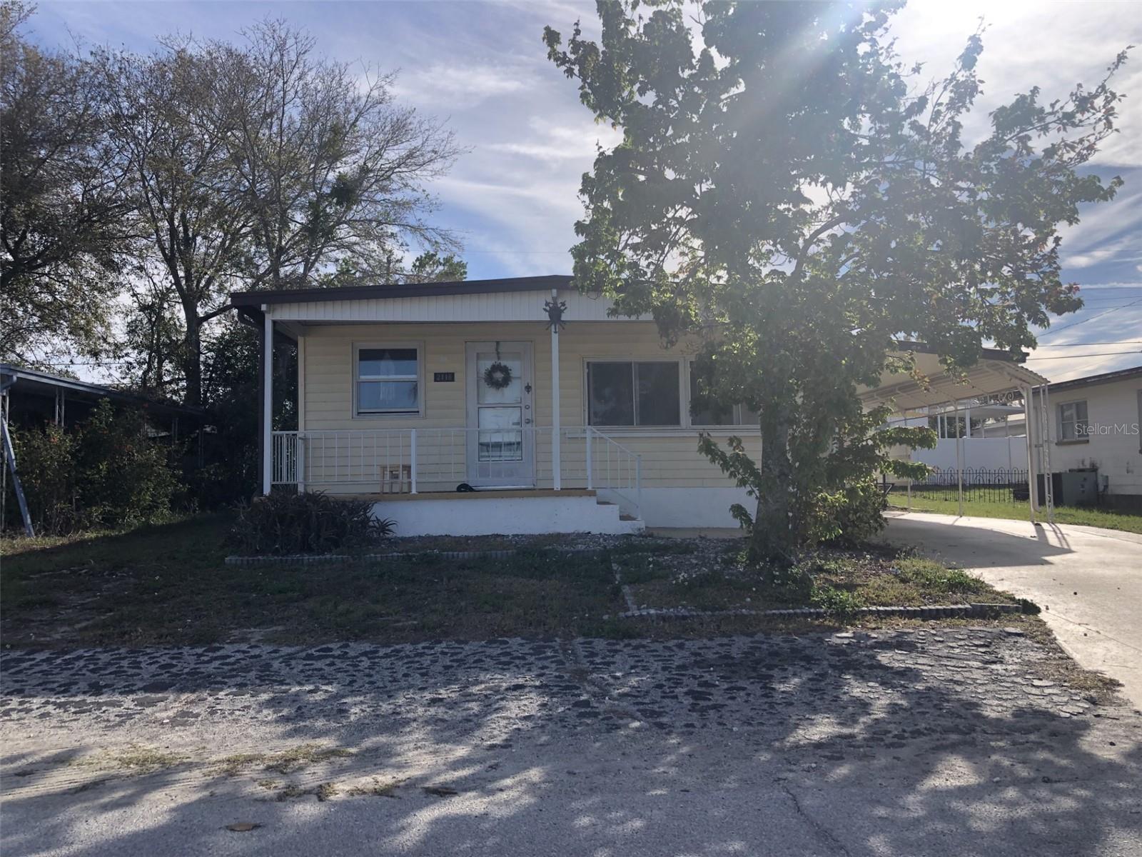 Offered as part of a divisible, four-property portfolio. Preference will be given to prospective purchasers that submit offers on all four properties. Please reach out to the listing agent for financial information on the portfolio. DO NOT SPEAK WITH ANY OF THE TENANTS OR ACCESS THE PROPERTY WITHOUT PRIOR CONSENT OF THE LISTING AGENT.
Three bedroom, Two-bathroom home in the Buena Vista subdivision. NO LOT RENT – the property is owned and may be conveyed on a fee simple basis. The kitchen offers newer stainless-steel appliances and pendant lighting. The kitchen opens to an open concept living dining room with tons of windows for natural lighting. The master bedroom is large enough for a king-size bed and has a step-in shower. No carpet throughout, offering easy Florida living. The home is served by a detached storage/ utility room, a covered front porch, a spacious sized back yard, and a shed with electricity. The back patio is great for relaxing and grilling. The metal roof is meant to last and was recoated in 2019. There is room to park three vehicles with a covered car port included. The low HOA of $109.50 per quarter covers the recreation buildings, shuffleboard Courts, horseshoes, streetlights and trash pick-up. The property is located near numerous shopping centers, restaurants, the famous Tarpon Springs sponge docks and local beaches. No flood insurance required X-500 Zone. Tenant in place for immediate income to potential investors.