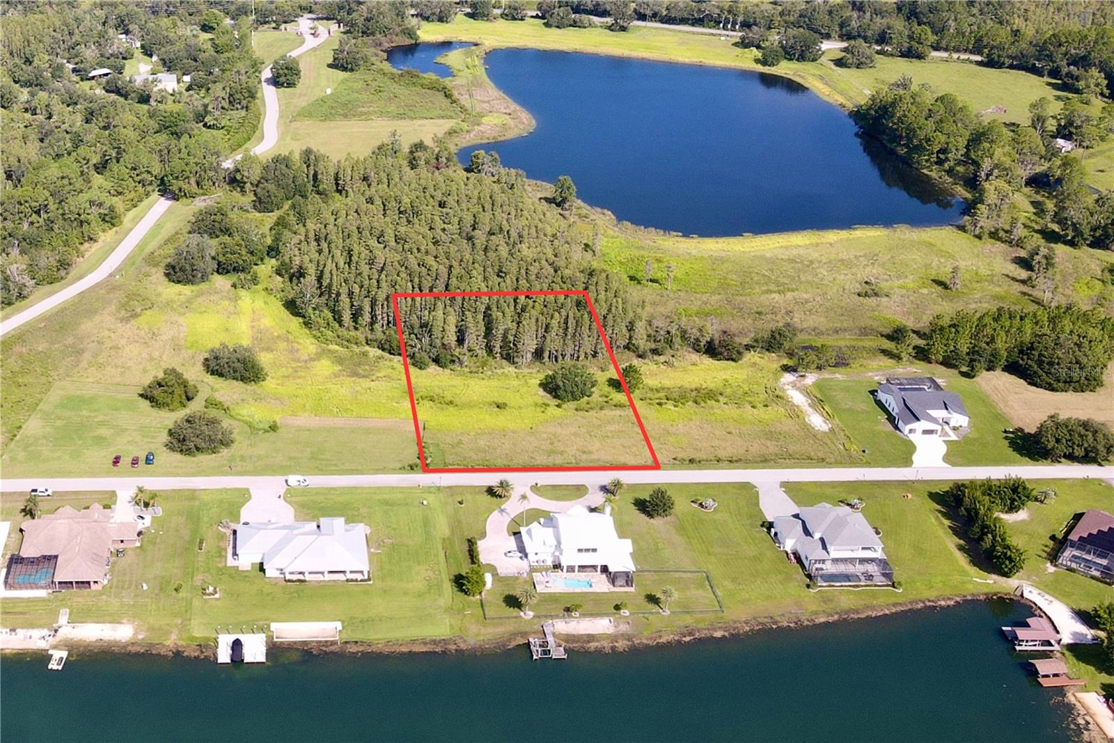Outlaw Ridge offers seven spacious residential lots ranging from 1 to 1.88 acres, nestled within a private, gated community designed for custom-built homes. Located in a quiet and scenic setting, the community offers a peaceful atmosphere surrounded by nature
and is ideal for those seeking a quiet lifestyle.
The available lots include a mix of wetlands and floodplain areas. Many of the sites back up to wooded areas or designated conservation land, offering serene views and privacy. Utilities are well and septic.
The lots are located within Outlaw Ridge, a gated community, on Outlaw Way and Hideout Trail in Land O' Lakes in Pasco County. Outlaw Ridge is situated on Ehren Cutoff. Ehren Cutoff connects US 41 to State Road 52.
The site is approximately 10 minutes from US Highway 41, where nearby medical shopping, and schools are located. Additionally, it's 1.6 miles from State Road 52, 5.9 miles from I-75, and 7.6 miles from the Suncoast Parkway. The area offers a mix of rural and urban surroundings. Due to its proximity to major thoroughfares, it's just a short commute from Wesley Chapel (20 minutes), Dade City (25 minutes), Brooksville (30 minutes), New Port Richey (40 minutes), Tampa International Airport (40 minutes), downtown Tampa (40 minutes), and downtown St. Petersburg (50 minutes).