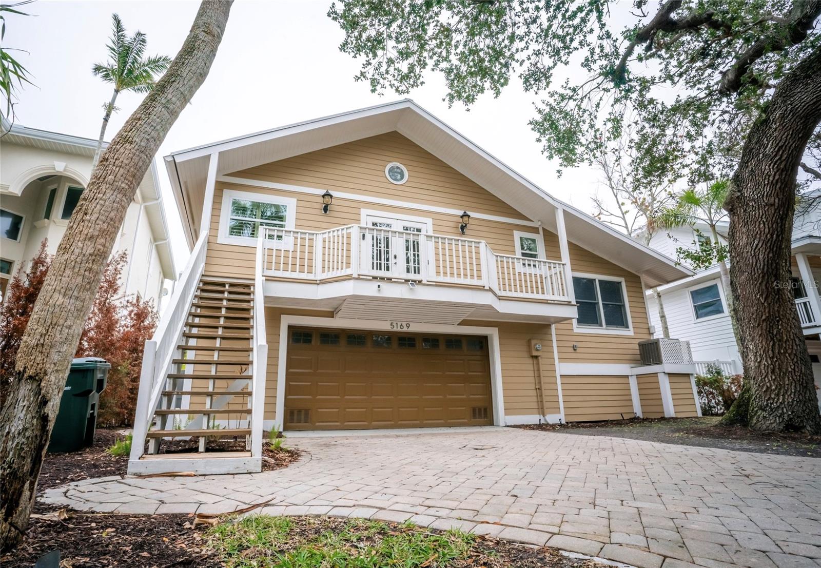 Welcome to 5169 Oxford Drive, a beautifully renovated waterfront home located in the heart of Siesta Key, Sarasota. This 3-bedroom, 3-bathroom residence offers the perfect blend of coastal charm and modern luxury, thoughtfully updated in 2021 with high-end finishes throughout. Inside, you'll find over 2,000 square feet of open living space featuring soaring ceilings, crown molding, and luxury vinyl plank flooring. The gourmet kitchen is a chef’s dream with built-in appliances, solid wood cabinetry, and an inviting eat-in area. The primary suite is a true retreat, complete with a custom walk-in closet and an integrated washer and dryer for added convenience. Step outside to your private backyard oasis where a heated in-ground pool and travertine marble deck create the ideal setting for entertaining or relaxing. Boaters will appreciate the reinforced composite dock with a 10,000-pound cradle lift, offering direct access to Siesta Key’s Grand Canal. Additional highlights include hurricane-impact windows, Hardie Board siding, plantation shutters, two newer A/C units, and professionally landscaped grounds with custom lighting and irrigation. Just a short walk or bike ride from the world-famous Siesta Key Beach, this turnkey home offers the ultimate Florida lifestyle in one of Sarasota’s most sought-after waterfront neighborhoods.