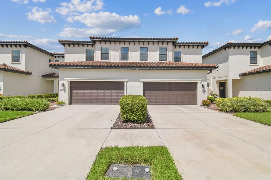 One or more photo(s) has been virtually staged. Best priced townhome in the heart of Carrollwood! A MUST SEE! Welcome to 13032 Sanctuary Village Lane, a stunning 4-bedroom, 2.5-bath luxury townhome offering 2,421 sq ft of heated living space in one of Tampa’s most desirable gated communities. Built in 2020 with a timeless tile roof and elegant architectural details, this residence blends modern sophistication with thoughtful upgrades throughout. Rich hardwood floors flow seamlessly across the entire home, complemented by quartz countertops in the kitchen and baths. The gourmet kitchen is a showpiece, featuring premium stainless-steel appliances, a spacious food pantry, and custom cabinetry. The open-concept design leads to a screened-in back porch with solar shades, perfect for relaxing in privacy. Additional enhancements include custom closets in every room, crown molding throughout, a loft conversion creating a true fourth bedroom, and a wireless security system with cameras for peace of mind. The garage is equally impressive with industrial-grade epoxy flooring, overhead storage racks, and a 2024 belt-drive opener with battery backup. Anti-theft window film and reinforced door jams add an extra layer of security, while brick pavers and an attic drop-down ladder offer both style and function. Located just minutes from Carrollwood Village Park, top-rated schools, shopping, dining, and major highways, this home delivers the perfect blend of luxury, convenience, and community. Don’t miss the opportunity to own this exceptional property in a prime location, make your appointment today!