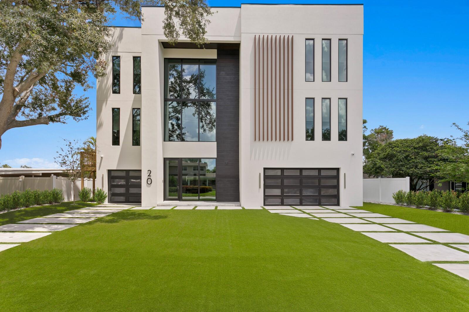 Incredible Value for a completed NEW construction MODERN BAYFRONT home in sought after Beach Park. This superior Bayfront location offers sweeping water views and quality custom construction, refined finishes and state-of-the-art design. Completed in 2023 by Modesta Homes, enjoy the best of waterfront living with a dramatic floating staircase, glass elevator, expansive water views, 6 bedrooms, 5.5 baths, 8,766 sq. ft. of living area, along with a new dock and seawall. Constructed with concrete block, impact windows/doors, and elevated living for flood risk reduction and optimal insurance premiums. Exceptional living spaces include a generous office, formal dining room, movie theater, waterfront Flex Room, lounge, entertaining bar, loft/gallery, along with a climate-controlled wine cellar. Created with spectacular entertaining in mind and offering full retracting glass doors to the waterfront terrace, a striking 360-degree fireplace centerpiece, sleek European-influenced chef’s kitchen with Wolf and Sub-Zero gas appliances, additional prep kitchen and generous island. Thoughtful design greets you in the primary suite with a modern aesthetic, terrace and water views, spa-inspired bath, deep soaking tub, custom floating vanity and closet beyond compare. Outdoors, enjoy a custom waterfront pool with fire fountains, floating spa, along with dual sun decks, dock and dual lifts (16K and 6K). Additional features in the energy-efficient construction include dual laundry rooms, 2-row home theater with 150” 4k Ultra HD screen, multiple waterfront terraces, 10-car garage and EV charging, Smart Home Systems, modern aluminum and glass impact garage doors, Low-E insulated/impact windows/doors, RHEEM Tankless water heater, Pentair automated pool control, imported tile and custom lighting, and tropical landscape/turf. Located in a top-rated school district and convenient to Westshore and International Mall, Tampa International Airport, shopping, dining, sports venues and entertainment. Available furnished at additional cost.