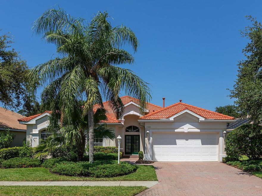 Situated behind the gates of Lakewood Ranch Country Club in the heart of Lakewood Ranch, this Neal Communities residence featuring the desirable Pinehurst floor plan with three bedrooms, two-and-a-half baths and a den. From the moment you step through the glass French doors, a double tray ceiling, chandelier and art niche set the tone for this thoughtfully designed home. Tile flooring extends throughout the main living areas, while rich wood floors add warmth to all bedrooms and the office. Step through the foyer into an expansive living room that seamlessly connects to the dining area, where crown molding and sliding glass doors create an elegant transition to the spacious lanai and pool — ideal for effortless indoor-outdoor entertaining. The dining area impresses with a double tray ceiling, statement chandelier and ample space for gatherings. The adjacent kitchen is a bright and functional space, featuring white cabinetry, Corian countertops, a large center island, well-maintained steel appliances, and an eat-in area framed by a picture window. The kitchen opens to a welcoming family room, complete with a built-in media wall and direct access to the lanai, offering a relaxed setting for everyday living. A spacious den is the perfect home office but could convert to another guest room if needed. The private primary suite features wood floors, two walk-in closets, lanai access, and a well-appointed en-suite bath with dual sinks, a makeup vanity, garden tub, walk-in shower, water closet and linen closet. Two well-appointed guest bedrooms feature wood flooring and spacious closets, with a full guest bath offering a tub/shower combo and large vanity. A half bath with pedestal sink is conveniently located near the main living areas. Completing the home is a functional laundry room with storage and well-maintained appliances, along with a two-car garage. Outside, enjoy lush landscaping, serene privacy, and a large, screened lanai with a sparkling pool and multiple areas for lounging or dining alfresco. With the recent expansion to include a fourth golf course, Lakewood Ranch Golf and Country Club offers unmatched access to premier golfing. Residents can choose from a variety of membership options. Ideally just minutes from The Mall at UTC, Waterside, Lakewood Ranch Main Street and downtown Sarasota, the home is also within easy reach of top-tier dining, shopping and the area’s renowned beaches. This beautifully maintained home offers the perfect blend of comfort, style and low-maintenance living in one of Lakewood Ranch’s most established golf communities.