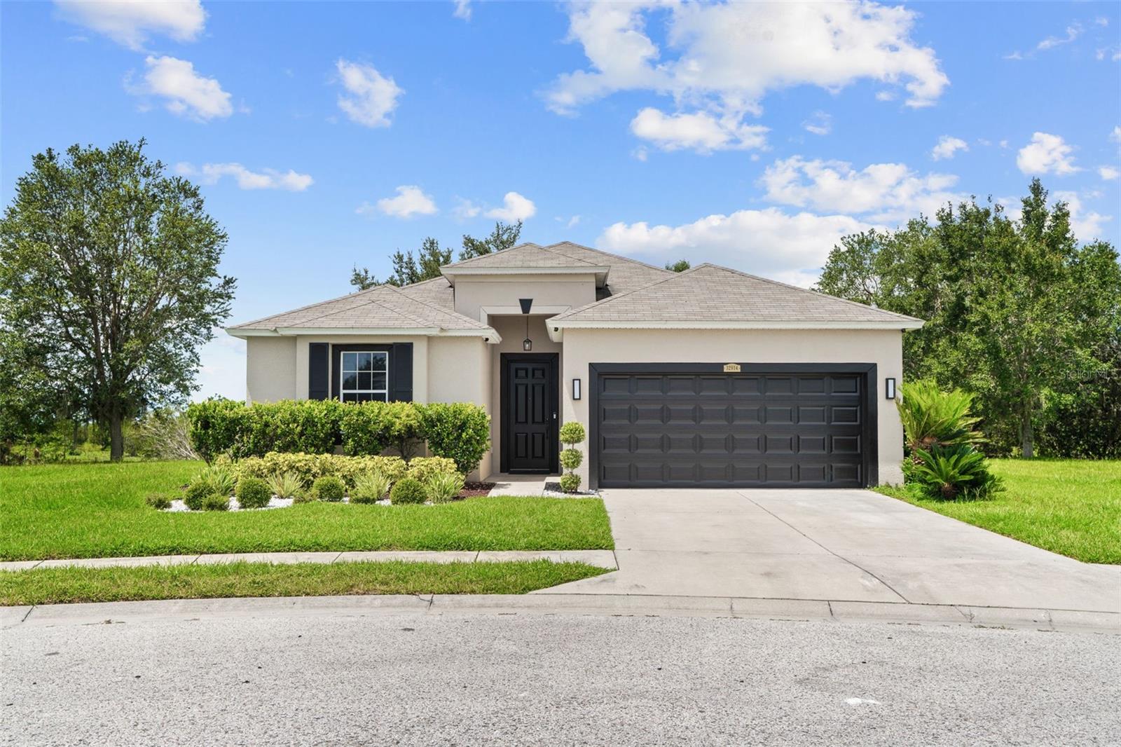 Welcome Home to Ashton Oaks! Tucked away in a peaceful cul-de-sac on an oversized lot, this beautiful home offers privacy, space, and convenience in the highly desirable Ashton Oaks community. Outdoor features include an expansive private yard with no backyard neighbors, lush landscaping that gives your new home amazing curb appeal and in-ground irrigation system for easy maintenance. Interior highlights include an open floor plan with vaulted ceilings and abundant natural light, 4 spacious bedrooms, 2 full bathrooms, large family room ideal for entertaining, Separate dining area for gatherings or casual conversation, and a gourmet kitchen with plenty of space to cook for the whole family during the holidays. The Primary Suite is a Secluded master bedroom with walk-in closet, En suite bathroom with double sinks, and bay window overlooking a tranquil nature reserve. Recent upgrades include Installed wood laminate flooring in all four bedrooms, A/C ducts cleaned and sanitized, UV light installed in the HVAC system, upgraded all lights with LED, new remote controlled ceiling fan with LED lights in the living room, new Smart LED light fixtures outside garage, Smart front door lock with key fob, fingerprint, PIN and regular key option, replaced all door handles throughout, replaced faucets and drains in both bathrooms, Wi-fi enabled Smart garage door opener, and upgraded irrigation system. Location, Location, Location: Conveniently located in Wesley Chapel, just minutes from Wiregrass Mall, a wide variety of restaurants and retail options, and easy access to I-75 and US-301. Community Perks: Low HOA fees, NO CDD, Low property taxes. Don’t wait—homes in Ashton Oaks move quickly! Schedule your showing today.