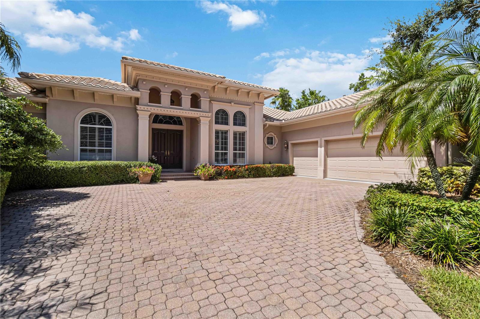 Offered Furnished, if desired. Located in the prestigious, guard-gated Silver Oak Estates on Palmer Ranch, this elegant John Cannon-built residence offers refined living on a generous lot with stunning lakefront views. From the moment you step through the double entry doors, you’re welcomed by soaring 14-foot tray ceilings and a breathtaking view of the heated pool, fountains, spa and expansive patio—all overlooking the length of the lake. It’s the perfect first impression of this thoughtfully designed home. With 3,876 square feet of single-level living, the layout features two spacious primary suites on opposite sides of the home, offering privacy and flexibility. In total, you’ll find four bedrooms, three and a half bathrooms and a large dedicated office—ideal for today’s lifestyle. The home is richly appointed with plantation shutters, crown molding, and 18” Italian porcelain tile in the main living areas. The chef’s kitchen is a showstopper, highlighting the induction cooktop, granite counters and island with prep sink & chandelier, wine cooler, NEWER KitchenAid refrigerator, double ovens, walk-in pantry and top-tier appliances. Both primary suites feature oversized walk-in closets and the home also includes a 3-car garage, laundry room with NEW washer and dryer and an outdoor summer kitchen—perfect for entertaining. Recent updates include, NEW hot water heater, NEW A/C units, NEW lanai cage and several freshly painted rooms. Residents of Silver Oak enjoy a tranquil, beautifully maintained community with 115 acres of lakes and protected nature preserves, all within minutes of Publix, Costco, the YMCA, Legacy Trail, championship golf courses, award-winning beaches, and downtown Sarasota’s vibrant arts and culture scene. Experience this exceptional property in person - schedule your private tour today. All information provided by the sellers is deemed reliable but is not guaranteed. Buyers are encouraged to verify all information independently