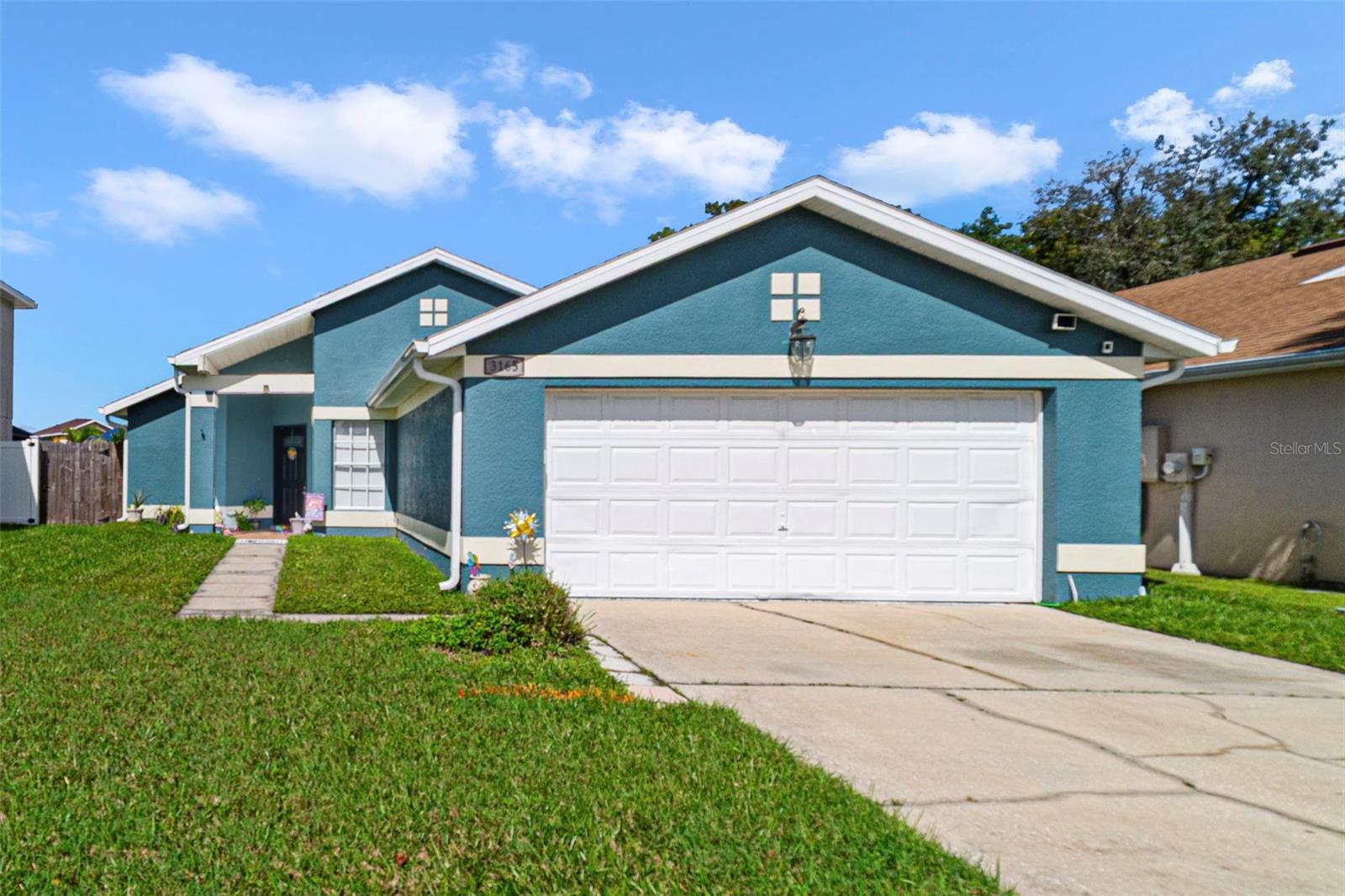 Welcome to Strafford Park, an established community in the heart of Kissimmee with unbeatable convenience, charm and a super LOW HOA! This single story home delivers an easy, OPEN LAYOUT with HIGH CEILINGS and stylish updates throughout. The spacious kitchen features shaker-style cabinetry, STAINLESS STEEL APPLIANCES, a breakfast bar for casual dining or entertaining, and an adjoining dining space – all flowing seamlessly into the living room where French doors open to a FENCED YARD and the perfect blank canvas to create the outdoor space of your dreams. You will appreciate the easy care WOOD LOOK TILE flooring in the main living areas, updated fixtures, and thoughtfully crafted accent walls that give the home a modern, welcoming feel. Your PRIMARY SUITE provides a comfortable retreat with a WALK-IN CLOSET and private en-suite bath, while bedrooms two and three share a second full bath. UPDATES include: the roof in (2017), A/C in (2018), and the WATER HEATER (2021) - adding peace of mind and value. Ideally located near SR 417, Florida’s Turnpike, and Orlando International Airport, with easy access to Lake Nona, shopping, dining, and Central Florida’s world famous theme – this home offers both comfort and convenience in one perfect package. Call today to schedule a tour!