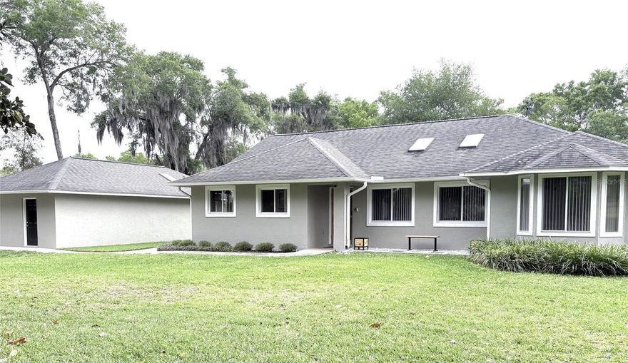 ¾ ACRE PROPERTY, 3 BEDROOM 2 BATH HOME, RV PORT, DETACHED GARAGE, WORKSHOP, FULLY FENCED, CITY WATER AND SEWER, MOVE IN READY   As you enter along the tree lined, driveway, you’ll discover this 3-bedroom, 2-bathroom home set on a quiet, ¾ acre lot nestled amongst the trees.  This fully renovated home features an open concept living area with skylights and a vaulted ceiling, a modern kitchen with stainless steel appliances, soft close cabinets and a spacious primary suite with walk-in closet. Enjoy outdoor living on your private screened lanai, great for relaxing evenings.  Perfect home for someone with lots of toys. The home has a detached two car garage, 20’ by 20’ workshop, and 24’ by 35’ RV Port with 50-amp electric service.  There is also a 10’ by 20’ two story building with storage on the bottom floor and a 10’ by 10’ play area on the second floor. Pride of ownership shines throughout.  Located just 1 ½ miles from downtown DeLand, you’ll have easy access to shops, dining and schools.  Don’t miss this opportunity to make this rare find yours. Schedule your private tour today!