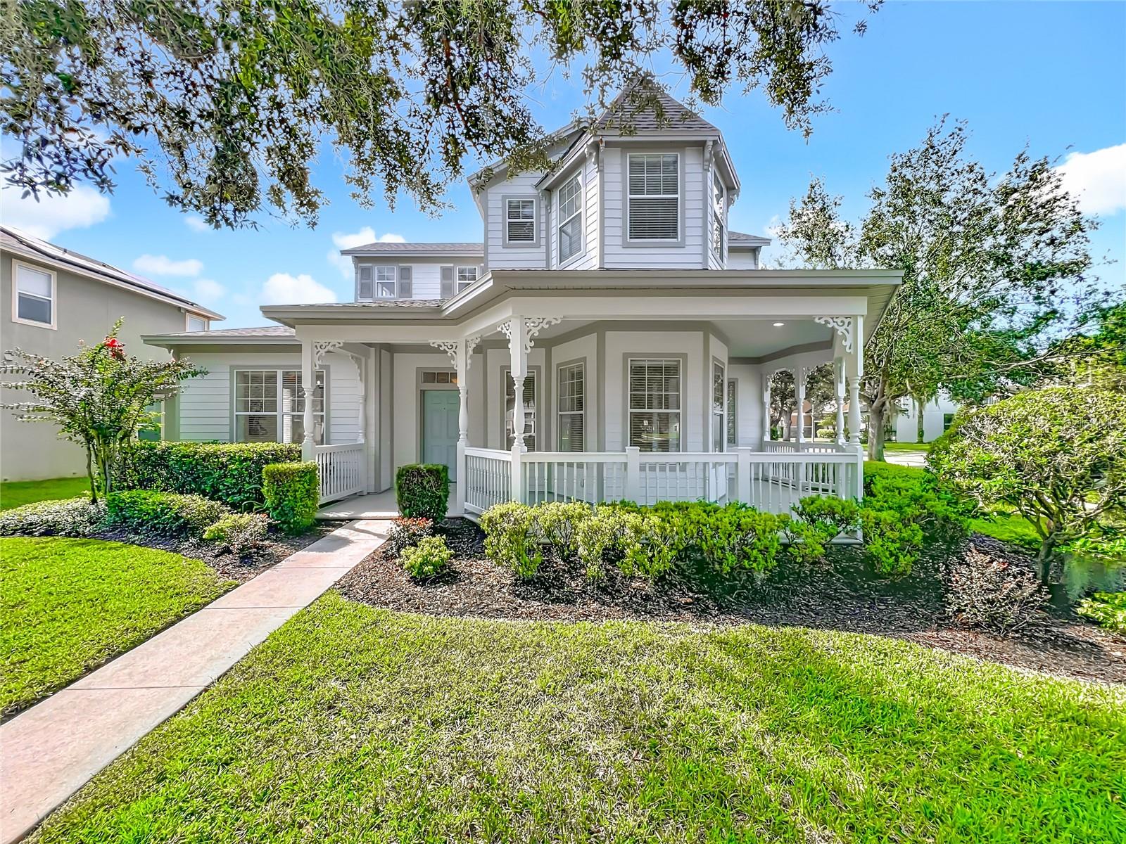 Beautifully upgraded, 4 bed, 3 bath, Victorian style home brimming with charm and character, nestled on a corner lot in the highly desirable Lakes of Windermere community. Situated on a beautiful tree-lined street with over 3100 sq ft of living space, the property welcomes you with pretty wrap around porch and mature landscaping. Upgrades include - NEW roof - 2025. NEW interior and exterior paint - 2025. NEW luxury vinyl plank flooring throughout - 2025. Kitchen upgraded in 2025 with NEW stainless steel appliances, quartz countertops, sinks, waste disposal, faucet, island cabinetry with custom surround. NEW custom TV built in with storage. NEW upgraded bathrooms including quartz countertops, sinks, faucets, tiling and toilets. NEWER AC and Water Heater. Inside, the home offers a perfect blend of elegance and comfort. The formal dining room and study/den are complemented by large windows with blinds and soaring 10-foot ceilings, arched entryways, stunning crown molding, and intricate wood trim details. The gourmet kitchen is a chef’s dream, featuring abundant cabinetry with custom details, a spacious prep or serving area, a large butler’s pantry and a walk-in pantry. Step out to the covered lanai to enjoy the best of Florida’s indoor-outdoor living. The HOA offers a host of amenities, including a community pool, park, playground, tennis courts, and dock. Conveniently located near Highway 429, this home provides direct access to all of Central Florida, just 10 minutes from Walt Disney World, and close to top-rated public and private schools, shopping, and dining. Experience the perfect blend of charm, convenience, and modern living by scheduling a showing today!