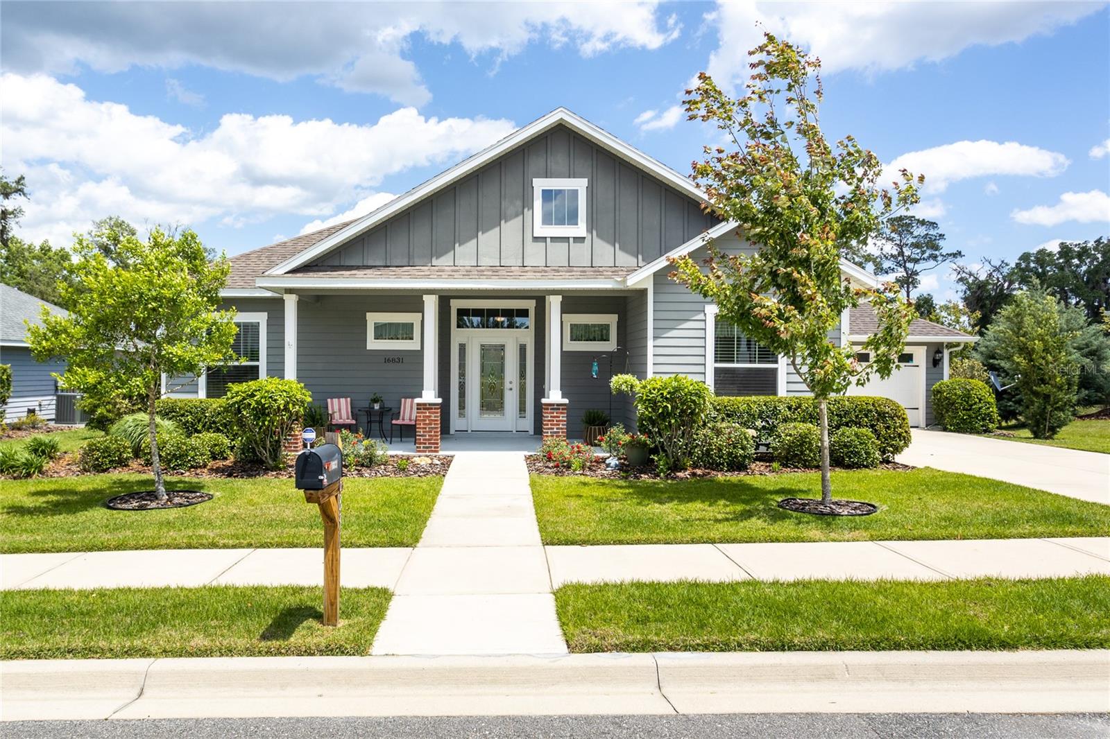 This 2017 Craftsman Style home has high ceilings, an open floor plan, split bedroom design and private back yard with garden view.
You'll be impressed by the quality features throughout the home, like the soaring multi-level ceiling heights, designer glass front door and foyer, tray ceilings, crown moulding, luxury vinyl plank flooring, large windows, inside laundry room and more. The kitchen is a standout feature, with specialty cabinet pullouts, under cabinet lighting, stainless steel appliances, granite counters, breakfast bar and a separate pantry. The home also has an extra tucked-away pocket studio/office and a generous alcove in the large owner's suite that provides additional versatile spaces.
Energy efficiency is a top priority in this home, with a 50 gallon RHEEM water heater, TRANE heat pump/AC, insulated garage door and ceiling, and Hardiboard siding contributes to the low monthly energy costs that average $160/month. The AquaSauna water filtration system, Structural Warranty and Simpli safe security system provide added peace of mind.
Step outside into the private backyard, that attracts colorful Blue Birds, Cardinals and more who chose to nest here year after year. Veggie Pod standup garden bed or traditional beds are brimming with tomatoes and more. There's plenty of room for a fire pit and barbecue, making this space perfect for outdoor entertaining.
The community offers many places to unwind, including a pavilion, playground, several green spaces, and dog-friendly, shady sidewalks. Nearby amenities such as Publix and Raceway make last-minute errands a breeze, and with quick access to major highways, Gainesville-Oaks Mall, UF Shands, and Lake City are all within an easy commute. All measurements are approximate only.