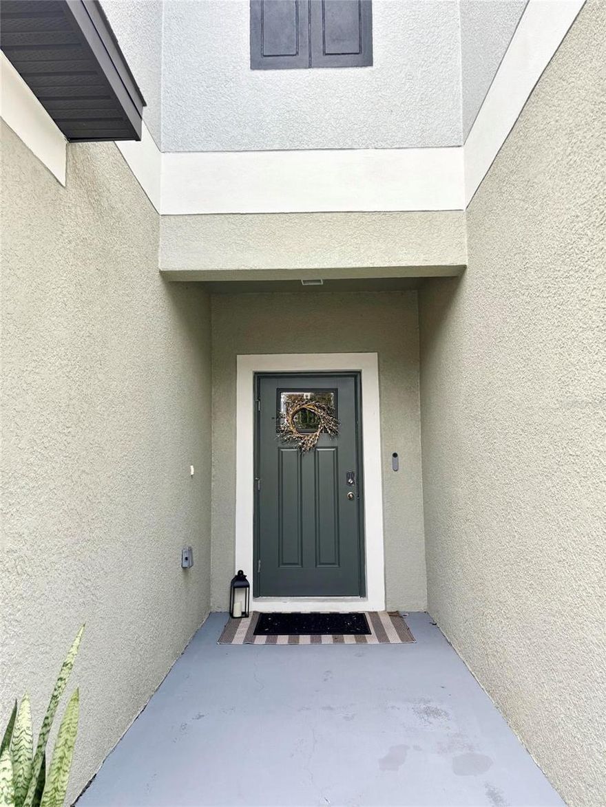 This exceptional 2022 built townhome conveys a serene view along with modern, maintenance-free living. NEWLY INSTALLED LUXURY VINYL PLANK on staircase and throughout second floor. This inviting home features two generous en-suite bedrooms, a flexible loft, two and a half bathrooms, and a one-car garage with OVERHEAD STORAGE RACK. The kitchen effortlessly connects to the living area and provides ample room for everyday living and entertaining. With sleek granite countertops, crisp cabinetry, a breakfast bar, and stainless-steel appliances, the kitchen is as stylish as it is practical. A sliding glass door off the kitchen leads to a screened-in back patio, an inviting spot to relax and enjoy the peaceful view. A convenient half-bath is also located on the first floor and includes a NEWLY INSTALLED VANITY and modern fixtures. Walk up the beautiful staircase, and the versatile loft adds extra living space, currently used as a home office. The primary suite serves as a peaceful retreat overlooking the pond, complete with walk-in closet and an ensuite bathroom featuring dual sinks and a walk-in shower. The second bedroom is also an en-suite, offering its own private bathroom and a spacious walk-in closet—great for guests or family members. For added convenience, the laundry room is located upstairs and includes washer/dryer and cabinetry. There is NO CARPET in this home. Additional upgrades include: block construction 1st and 2nd floor, site premium, crown molding, upgraded bathroom fixtures, impact windows, and hurricane shutters. HOA includes water, exterior maintenance, and grounds maintenance. No need to mow your lawn ever again! No CDD fees. Walk to EOS Fitness, Fresh Kitchen, Aldi, Chick-fil-A, and more. Ideally situated with easy access to the Veterans Expressway and I-75. Fully transferable home warranty.