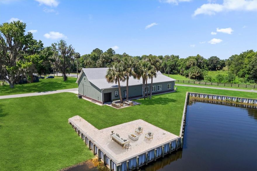 One or more photo(s) has been virtually staged. Brand New, One-of-a-Kind Lakefront Home in Orange Lake Shores!

Welcome to the newest and most exceptional home to hit Orange Lake Shores in years — a custom-built lakefront masterpiece where luxury, durability, and thoughtful design come together. With breathtaking water views and direct lake access, this home is perfect for full-time living or a seasonal escape.

Built with 11-inch-thick insulated concrete form walls rated for 140+ mph winds, James Hardie board siding, and elevated safely above FEMA's 100-year flood line, this home is made to last. Inside, enjoy 11-foot ceilings, smart home features with USB outlets in every room, and a 400 AMP electrical service with generator hookups and RV connection.

The home includes a standard, easy-maintenance septic system, engineered HVAC with dehumidifier, two tankless water heaters, and a top of the line water filtration system. An ADT security system (owner-owned) is ready for transfer.

Entertain in style with a custom kitchen and wet bar featuring granite countertops, a KitchenAid wine cooler, and pass-through to the living area. There are seven sinks, plantation shutters on all windows, and built-in features throughout. The oversized laundry room, butler’s pantry, and abundant cabinet space add functionality and flair.

Each bedroom offers built-in granite counters and storage. The property also features outdoor hot/cold shower, underground drainage, fresh sod, and multiple refrigerator hookups — including one in the shop for an ice machine.

Located just minutes from Gainesville, Ocala, and Florida’s natural attractions, this is more than a home — it's a rare opportunity to own a lakefront dream unlike anything else on the market.