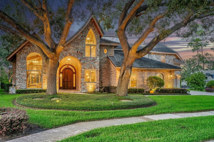 Experience the epitome of luxury in this Lake Front masterpiece, deemed Castillo Del Lago (Castle of the Lake) located on an exclusive cul-de-sac hidden amongst 3 lakes! Immerse yourself in the charm of Old-World European architecture and craftsmanship as you enter the home through a 9.5ft arched wood door with elegant side lights. Greeted by a grand staircase, soaring ceiling heights, rustic beams, exquisite stone accents, and panoramic lake views that will leave you breathless from every room. Indulge in the grandeur of the main home, offering 4 bedrooms and 4.5 bathrooms, polished marble floors, and dazzling chandeliers. Cedar ceilings add a touch of rustic elegance and warmth, with not just one, but two Primary Suites on each level of the home providing the ultimate in comfort and privacy. For the culinary enthusiasts, the chef's kitchen is a dream come true, custom cabinetry, stained glass lighting, exotic granite island, and elegant copper touches. A formal dining room sits just off the kitchen featuring a designer wine closet. Retreat to the spacious downstairs owner's suite boasting separate his and hers bathrooms and a walk-in closet with entrance through a hidden built-in door. The main level of the home provides a dedicated office space as well as 3 living areas for all your entertaining needs.
 Indulge in luxury at every turn as you travel upstairs, with a private balcony off the second Owner's suite overlooking the lake. This incredible space offers a generous built-in closet and dressing room, along with a full marble bathroom featuring heated floors, whirlpool tub, and a multiheaded shower for the ultimate pampering experience.
But that's not all, embrace the unique charm of the 25 ft Cedar wood Turret circular room, cherry wood flooring, 2 additional bedrooms on the upper level, and a stunning wrought iron banister that adds a touch of elegance to the grand staircase. A separate guest quarters is offered above the 983 Sq/Ft 4-car Garage which has its own split unit AC providing heat as well. 
The upstairs guest quarters overlook the lake and has ample room for sleeping and living as well as a full kitchen with gas stove, dishwasher, and bar top area for dining. A full marble bathroom with onyx tile and large walk-in closet along with 2 closets for storage make this room flexible enough to be an entertainment room or space for multigenerational families. Step outside of the main home and be captivated by the resort-like oasis that awaits you. Here you will find a sparkling pool with a fenced patio, hot tub with a mesmerizing water feature, sitting area fitted with a gas line for firepit, and your very own boat dock, perfect for endless adventures on the lake. Don't miss your chance to own this exquisite luxury home, where every detail has been carefully curated to provide a lifestyle that exceeds all expectations. Contact us today to schedule your private tour and witness the epitome of opulence!