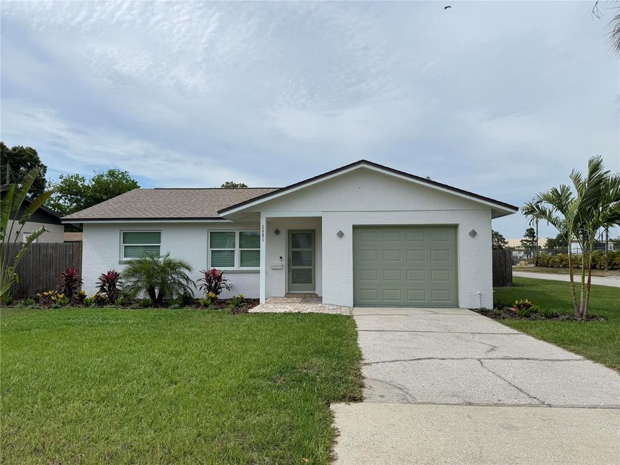 This fully remodeled home has everything you need to start living the good life in North Kenwood! This corner lot has a fenced backyard and is beautifully landscaped for privacy. Attached to the rear of the home is a 12' x 25' covered patio with pavers extending the full length of the home. An additional 9' x 15' paver patio is located on the side of the home and can be used for a shed or any other purpose. The home is located in flood zone X which means you are not at risk of flooding.

Inside the home you will find 2 bedrooms and 1 bathroom. The flooring throughout is wood tile, 9 inch wide planks in a neutral, warm tone. The kitchen has marble counters with a waterfall island, new cabinets, stainless appliances and a green jade backsplash. A stackable washer and dryer is located in the closet beside the fridge. 

The bathroom is all new with grey tile around the shower and vanity. The cabinet is topped with a bowl sink and waterfall faucet along with marble counters. The seamless glass shower doors and brushed stainless fixtures finish off the modern look. 

This home is a must see! Almost everything has been replaced and modernized. The 1 car garage includes a charger for an electric car. The full irrigation system, sod, landscape is new. The windows and doors are tempered and hurricane rated, the patio is strapped to the ground and rated for 100mph winds. The electrical was updated, all interior walls and ceilings were textured and painted, the exterior was painted. All interior moldings and trim and new. The tankless water heater, garage door opener, exterior fixtures and door handles, interior doors  are new. The roof and A/C are approximately 10 years old but look and operate like new!