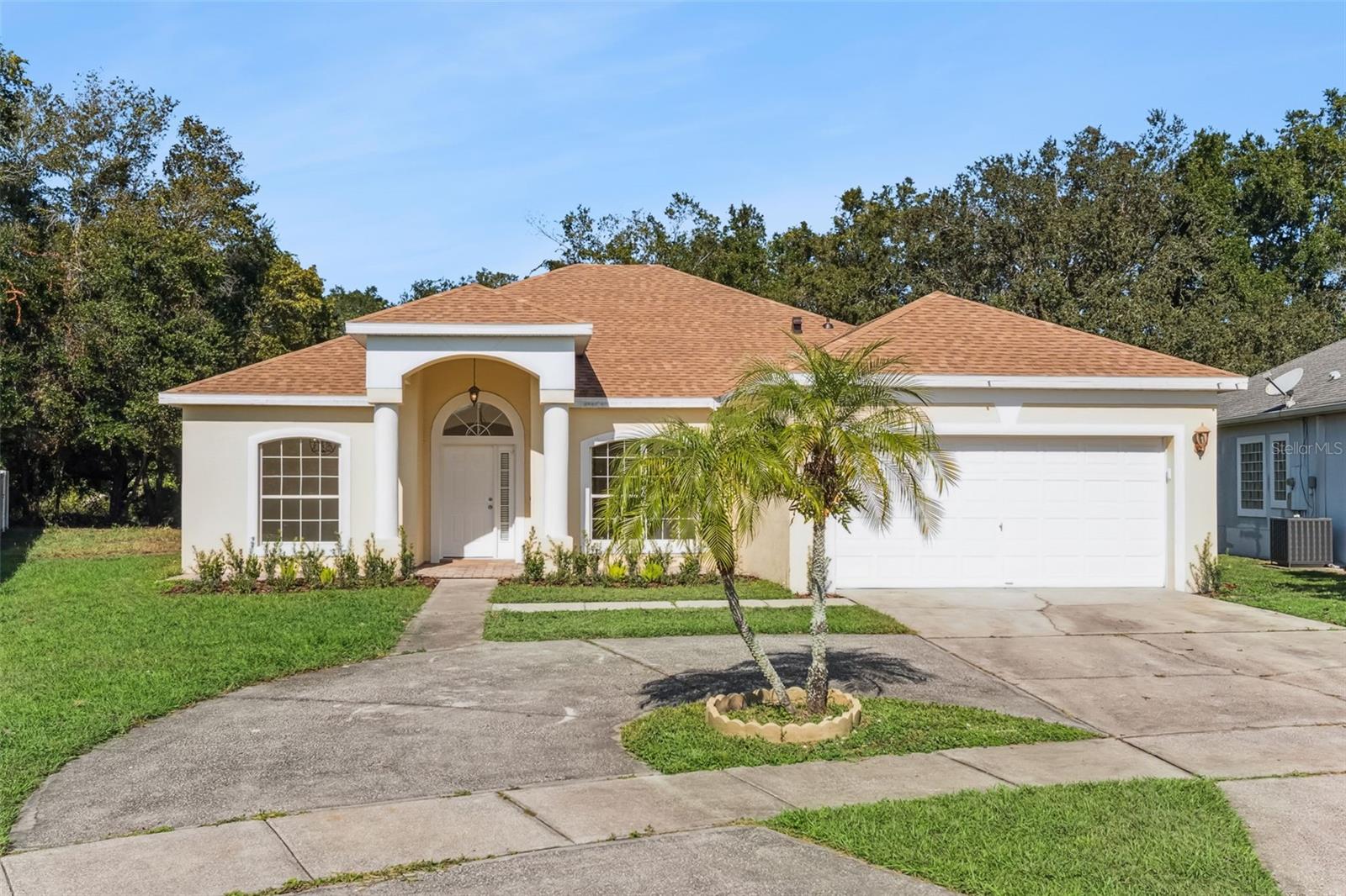 This beautifully updated single-story home offers 3 spacious bedrooms and 2 modern bathrooms across 1,847 square feet of living space. Recent upgrades include a new roof, well-appointed kitchen with quartz counters, new appliances, elegantly updated bathrooms, and AC system, ensuring comfort and peace of mind for years to come. The open floor plan is enhanced by cathedral and vaulted ceilings, creating a bright and airy atmosphere throughout. A split-bedroom layout provides privacy, with the primary suite serving as a serene retreat, complete with elegant crown molding and a bathroom en-suite with a luxury soaking tub, dual sinks and an oversized walk-in closet. The circular driveway adds curb appeal and convenience, complemented by a roomy 2-car garage. Durable tile flooring flows throughout the home with wood laminate in the additional 2 bedrooms. Situated on a generous 0.28-acre lot in a welcoming neighborhood ideal for comfortable living, this home blends timeless charm with thoughtful updates.
