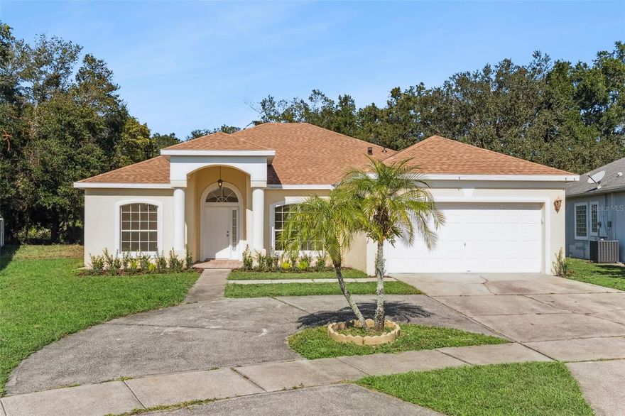 This beautifully updated single-story home offers 3 spacious bedrooms and 2 modern bathrooms across 1,847 square feet of living space. Recent upgrades include a new roof, well-appointed kitchen with quartz counters, new appliances, elegantly updated bathrooms, and AC system, ensuring comfort and peace of mind for years to come. The open floor plan is enhanced by cathedral and vaulted ceilings, creating a bright and airy atmosphere throughout. A split-bedroom layout provides privacy, with the primary suite serving as a serene retreat, complete with elegant crown molding and a bathroom en-suite with a luxury soaking tub, dual sinks and an oversized walk-in closet. The circular driveway adds curb appeal and convenience, complemented by a roomy 2-car garage. Durable tile flooring flows throughout the home with wood laminate in the additional 2 bedrooms. Situated on a generous 0.28-acre lot in a welcoming neighborhood ideal for comfortable living, this home blends timeless charm with thoughtful updates.