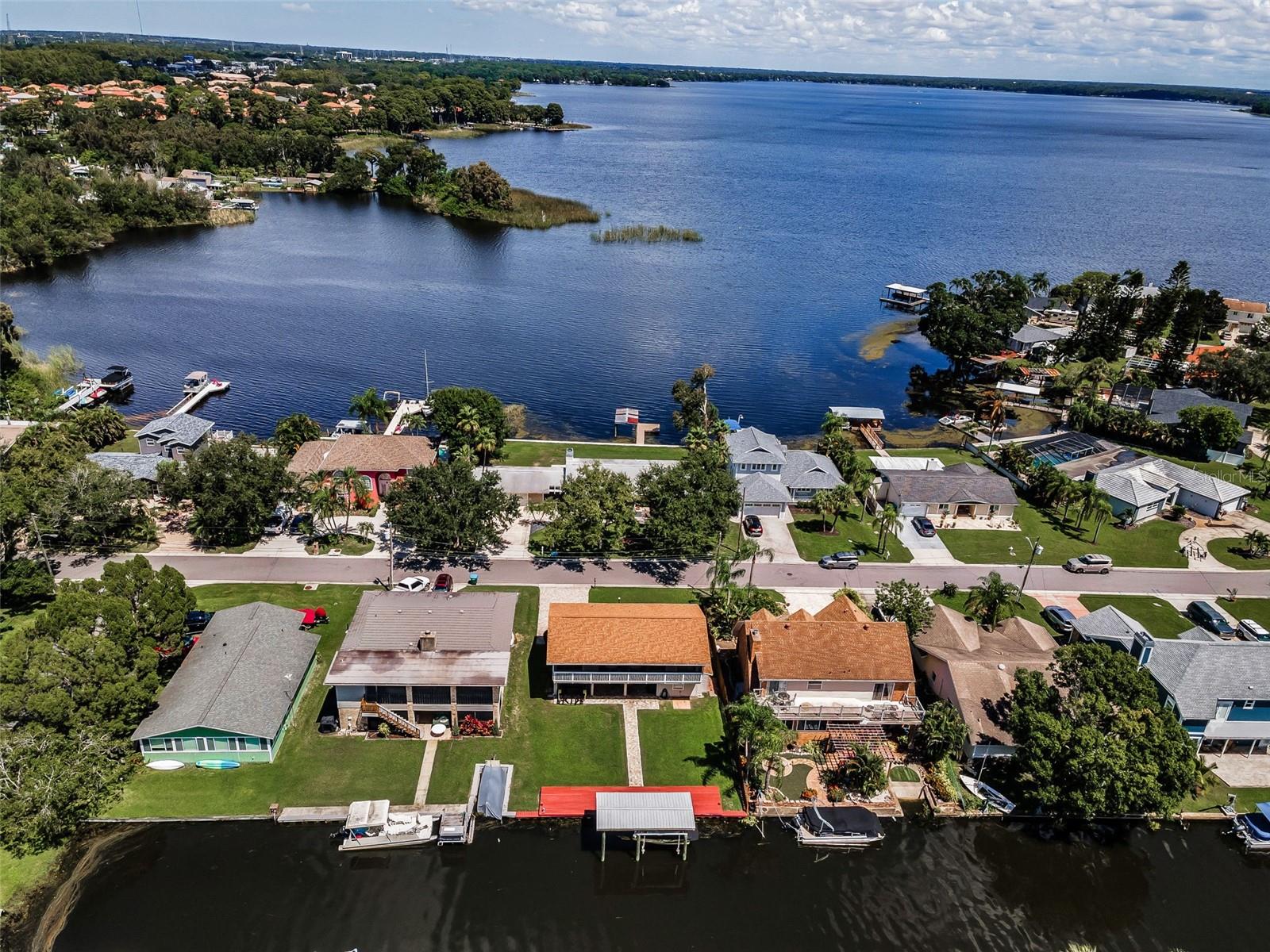 Lake Tarpon Waterfront Home with Boathouse!
Welcome to this beautifully updated three-bedroom, two-and-a-half bath home on the shores of Lake Tarpon. From the moment you arrive, the paver-lined exterior, lovely landscaping, and inviting entry foyer set the tone for a property that balances comfort, flexibility, and waterfront living.
The main living and kitchen area are located on the second level, offering an open-concept design with engineered hardwood floors throughout. Natural light fills the space, creating a warm and welcoming atmosphere for entertaining or relaxing. On this level are also the Primary & 2nd bedroom and two newly remodeled bathrooms are as well.
On the entry level, the spacious foyer leads to an area with the potential for a mother-in-law suite or private studio, or 3rd bedroom, complete with its own 1/2 bath & separate entrance—perfect for extended family or guests.
Outdoors, the property is equally impressive. Recent newer upgrades include a boathouse, seawall, roof, remodeled bathrooms, and a water softener and a reverse osmosis system~with most of the big-ticket items already completed (too many to mention). A/C & Hot water tank were replaced in 2017. The boat in the boathouse is also available, along with Boat trailer—please see agent for details.
Enjoy true Florida living with a screened-in lanai accessible by sliders from both the primary bedroom and the living room, offering a seamless flow to the outdoors. Beyond the lanai, the backyard patio overlooking Lake Tarpon creates a wonderful gathering space for family and friends, perfect for lakeside get-togethers, sunset dinners, or quiet mornings with coffee.
With direct lake access, you can enjoy fishing, boating, and water-sports, or cruise across the water to the popular Tarpon Turtle Restaurant. Surrounded by pavers and beautifully landscaped grounds, this home is designed for both easy maintenance and outdoor enjoyment.
Don’t miss the opportunity to own this turnkey Lake Tarpon retreat where upgrades, location, and lifestyle come together. This location is also near famous beaches, airports & entertainment galore.