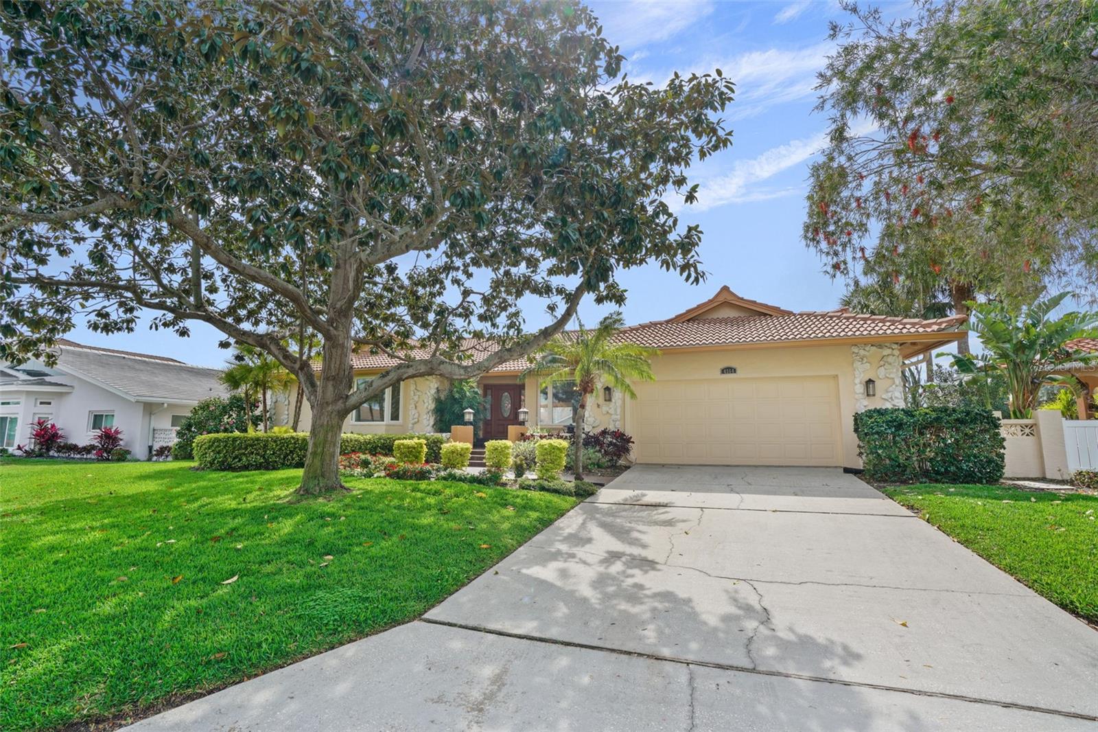 Located in the hidden gem of beautiful Bayway Isles, this waterfront home is truly a rare find! Immediately feel at home in this 24 hour guard gated community. With approximately 2800 square feet of living space, including 4 bedrooms, and 3.5 baths, this single story home is designed with thoughtful spaces throughout. The bedrooms are split across the home so you can experience the privacy you need with the primary bedroom located separate from the main living areas. Enjoy your gorgeous en-suite primary bathroom with double sinks, large shower and additional seating area for convenience. Easy access to the pool through the sliding doors located off the primary bedroom. Stunning Brazilian walnut flooring adorn the living and dining areas providing a timeless touch upon entering the home. A wood burning fireplace surrounded by stone is included in the great room. Granite counters align the spacious kitchen, which includes an abundance of cabinetry for all your cooking needs. Stainless steel GE appliances, including a brand new dishwasher, and under cabinet lighting brighten the space while your time is spent here. Outside, you’ll find a large screen enclosed deck, including a private pool and spa, where you can take time to relax overlooking the bay. UPDATE: Pool deck/ceiling/walls on outside pool deck have been painted off white since photos were taken. Enjoy access to the dock with a 10,000 pound boat lift, providing you ease and convenience for all your boating needs. The very spacious laundry room, located off the 2 car garage, provides plenty of additional cabinet space, and room for extra household items. The garage includes new epoxy flooring. This home is a must-have for those looking for waterfront living in a convenient, private location! Did not flood from Helene or Milton! Located within 10 minutes to the beaches and easy access to I-275.