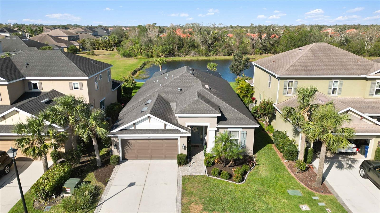 Welcome to this meticulously maintained Pinehurst III Model with a custom SALTWATER POOL and stunning LAKE VIEWS. Situated in the highly sought after Arbor Lakes community! This exquisite home exudes elegance from the moment you arrive with beautiful landscaping, an extended driveway, pavers walkway, and an 8-ft door that opens to this bright and spacious home. Featuring high ceilings, 3 bedrooms plus a Den/Office, 2 bathrooms, and many impressive upgrades. Just off the foyer you will find double doors leading to the den that can be used as an office/playroom/media room which includes a built-in desk with ample storage and a custom murphy bed. The kitchen provides newer stainless-steel appliances, updated 42-inch cabinets, quartz counters, a natural gas stove, a pantry, and an eat-in dining area. Retreat to the spacious master bedroom that is highlighted with a gorgeous custom feature wall, large his and hers walk-in closets, and a private en-suite bathroom with double vanities, a garden tub, and a large walk-in shower with a frameless glass enclosure. This home was freshly painted inside and out and also comes with updated lighting, fans, in-wall pest control system, reclaimed water sprinkler system, shelving in the garage and much more. Step outside into your private OASIS! Your eyes will immediately be drawn to the gorgeous custom saltwater pool with added water features, a sundeck, lighting, and gas pool heater. Relax outside on the extended patio overlooking the beautiful lake and amazing sunsets. Surround sound outdoors and TV hook-ups are provided for added entertainment. The built-in outdoor cooking area is equipped with granite countertops and a Blacktone Griddle & Air Frier. This impressive home shows like a model!!! Located in one of the most sought-after communities in Palmer Ranch with A-rated schools, No CDD fee, 8 Miles east of Siesta Key Beach, 1 mile to the Legacy Trail, shopping and restaurants nearby. Arbor Lakes offers a wide variety of activities including a basketball court, beach volleyball, a resort style community pool, a hot tub, pavilion with grills, a splash park, fire pit, playground, sidewalks throughout, and a dog park. Come enjoy all that Arbor Lakes has to offer!!