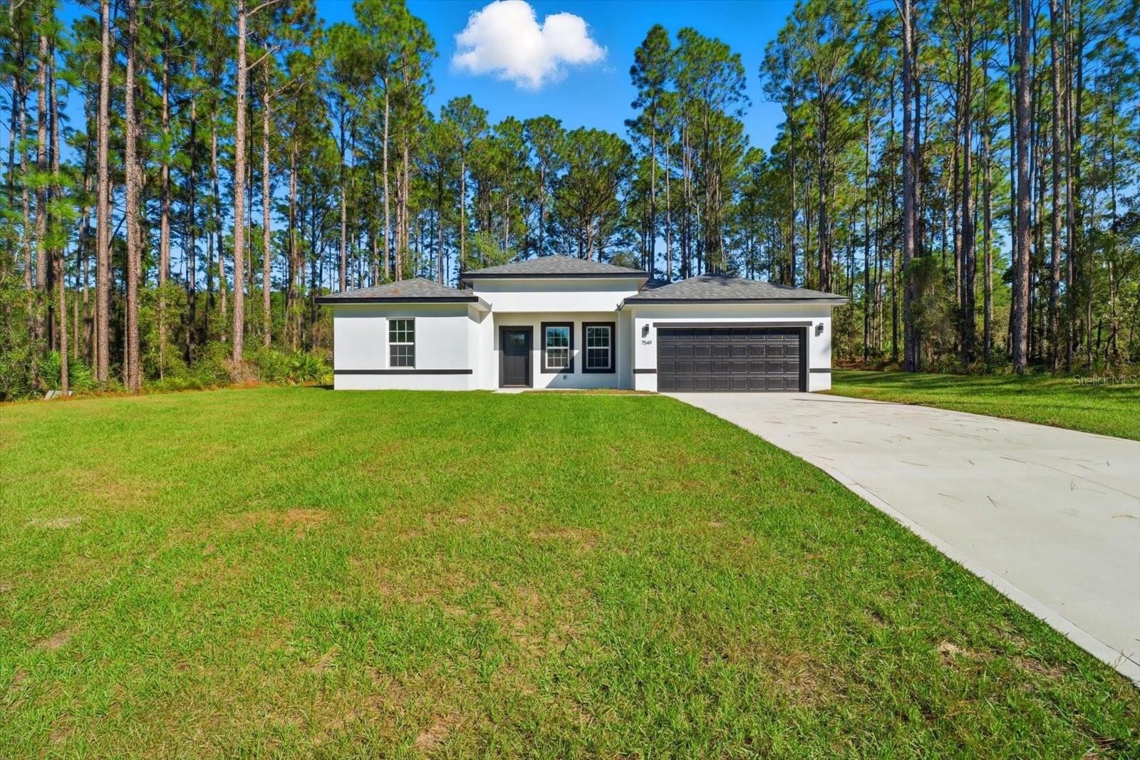 Brand new 2025 built 4/2/2 modern home inside and out. Located in a no flood zone and no HOA! Welcome to Citrus Springs where you are centrally located in the community. You will have Dunnellon to the north known for the famous Rainbow River. Travel west for Crystal River known for its natural springs and rivers that lead out to the Gulf. To the southeast is Hernando and Inverness with the chain of lakes. This home offers all of the upgrades that you would expect, from the granite countertops, shaker style wood cabinets, soft close drawers and doors, stainless steel appliances, drop lighting, recessed lighting, large tiles in the showers, black hardware on doors and cabinets and black faucets really make this beauty stand out! Inside laundry room is right off of the master which is brilliant! The other three bedrooms are on the other side for added privacy. Large 2 car garage as well as a lengthy back porch that is under roof. There is also enough room for a future pool. Make your appointment today!!