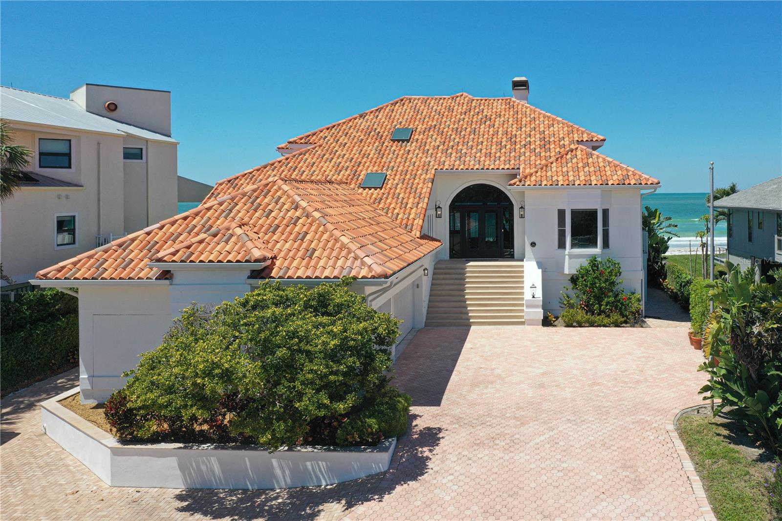 The Belleair Beach House... A Luxurious Gulf Front Home with a Pool and Coastal Elegance! Escape to a beautiful Gulf front home in a secure gated location. This two-story home is located on Belleair Beach! This stunning home sits directly on the sand! Drive up the circular driveway and feel the excitement for the coastal retreat ahead. Your eyes are immediately drawn to the grand staircase and direct beach views! Enter the great room with a fireplace and stylish built-ins. Enjoy special dinners in the formal dining room. French doors lead to a covered Gulf front terrace connected to the breakfast room. The open kitchen is a culinary delight with a new stainless French door refrigerator, double ovens, and a handy island with a five-burner glass cooktop. A Gulf front bedroom with an exterior door for pool or beach access and a hall bath enhance the coastal living experience. Another guest bedroom with a private bath ensures a comfortable stay. On the second floor, the master retreat features a second fireplace, vaulted ceiling, and sliding doors to a sun deck. Enjoy the luxury of a walk-in custom closet and a master bath with custom marble, a tub, glass shower, and dual sink vanity. Another bedroom on this level shares the sun deck and offers a walk-in closet and private bath. Elevate your stay with the convenience of an elevator, a well-appointed laundry room with a safe, and a half bath. This fully renovated waterfront oasis continues outside with a sparkling pool and spa. The three-car side entry garage provides ample space for your convenience. Experience coastal luxury in this meticulously crafted vacation rental, where every detail has been carefully chosen for your ultimate relaxation and enjoyment.