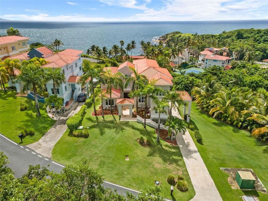 This modern cliff-side estate home with awe-inspiring ocean views is for sale in the renowned Palmas del Mar Resort. Upon entering the home, you are greeted by a grand double height ceiling with a wall of glass that brings in natural light and provides stunning views of the palm trees and ocean beyond. The main level features a remodeled open kitchen with quartz countertops, a window over the sink with views of swaying palm trees, and a living room with wet bar that opens to a large balcony overlooking the ocean and pool. There is also a family room and formal dining room on this level. While a bedroom with an ensuite bathroom, office, and half bathroom complete this floor.

Upstairs you will find three additional bedrooms all with ensuite bathrooms as well as the master suite. The master suite features beautiful ocean views from the private balcony and from the bed itself. The spacious master bath has double sinks, a walk-in shower, and a walk-in closet. There is also a large laundry room on this level for your convenience.

The lower level of this magnificent home houses a family room as well as an additional bedroom with an ensuite bathroom. This would be perfect for guests or extended family visiting on vacation. 

Outdoors you will find a lovely pool, hot tub and patio area with travertine flooring, gazebo, and plenty of space for entertaining or simply relaxing in the sun. The incredible ocean views and dramatic cliff-side setting provide the perfect backdrop for this idyllic home. There is also an outdoor BBQ area as well as its own pool bathroom – making it easy to take care of all your needs without ever having to leave your backyard oasis! 

With top-of-the-line windows and doors that are thermally efficient and hurricane resistant this home is built to withstand anything Mother Nature can throw at it. The estate also comes with a generator – ensuring you are never without power, even during the most severe weather conditions.

Walking distance to the beach and access to all the amenities that Palmas del Mar Resort has to offer, this is truly a one-of-a-kind opportunity. Don’t miss your chance to own a piece of paradise!

PALMAS DEL MAR RESORT
Palmas Del Mar is a world-renowned resort community that offers a wide range of amenities to its residents that are just a golf cart ride away. From championship golf courses to, tennis, equestrian center, beach club and a world-class marina, there is something for everyone to enjoy. There are also several restaurants, retail stores, and a grocery store located within the community. And with five miles of coastline, including two miles of beach, there are plenty of opportunities to enjoy the outdoors. Families will appreciate the Palmas Academy, which offers an English language education from pre-kindergarten to 12th grade. With so much to offer, it's no wonder Palmas Del Mar is one of the most sought-after communities in Puerto Rico.