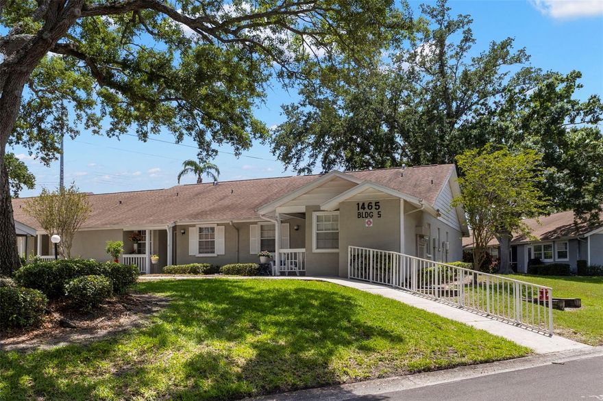 One or more photo(s) has been virtually staged. Tucked within a beautifully maintained community, this updated 2-bedroom, 2-bath end-unit villa offers comfort, convenience, and carefree Florida living at its finest. Your monthly HOA fee includes sewer, water, trash, cable, internet, grounds and exterior maintenance, plus reserves—making everyday living as effortless as it is enjoyable. Step inside to discover an inviting open-concept layout highlighted by soaring vaulted ceilings and abundant natural light. The updated kitchen is both stylish and functional, featuring soft-close cabinetry, gleaming granite countertops, decorative tile backsplash, a built-in pantry closet, breakfast bar seating, and space for a casual dining table. The kitchen flows seamlessly into the spacious great room, creating the perfect setting for entertaining or relaxing at home. Just beyond the living area, pocket sliding glass doors open to a versatile bonus room with exterior access—ideal for a home office, reading retreat, hobby space, or additional sitting area. The private primary suite is tucked toward the rear of the home and features a large walk-in closet and an en-suite bath with a step-in shower. The secondary bedroom also boasts a generous walk-in closet and is conveniently located near the second full bathroom, complete with a soaking tub and linen closet. Additional highlights include an in-unit laundry room just off the front entry hall with washer and dryer hookups plus extra storage space. Residents enjoy access to a sparkling community pool and a prime central location close to beautiful beaches, shopping, restaurants, and so much more. This charming villa blends low-maintenance living with tasteful updates and an unbeatable location—ready for you to call home.