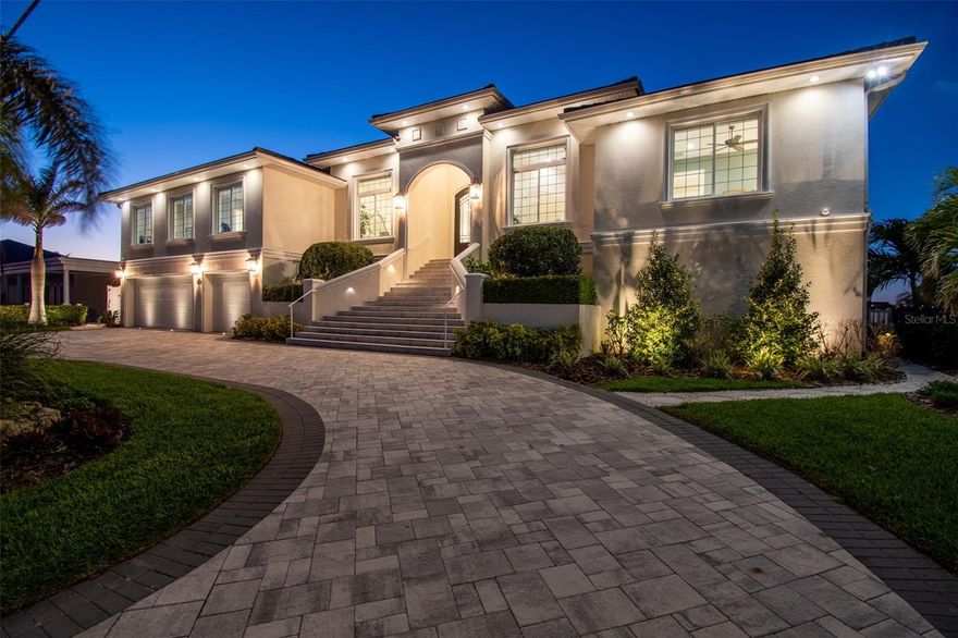 Step into this exquisite custom-built elevated waterfront home, nestled in coveted Brightwater Beach Estates and prepare to be in awe! A true coastal retreat, this FEMA-compliant masterpiece boasts unparalleled panoramic views of tranquil Boca Ciega Bay, with each bedroom and living areas offering unobstructed vistas to the north and south. The home features impeccable craftsmanship with every detail thoughtfully considered, from the luxurious tile flooring and elegant crown molding to the coastal-chic decor that is fresh, neutral, and elegant.
Designed for both comfort and style, the expansive floor plan offers 5 spacious bedrooms (2 currently used as offices), 4 full bathrooms (3 of which are ensuite), state-of-the-art Thermador kitchen appliances, custom kitchen cabinetry and an oversized laundry room. The gracious open layout is perfect for entertaining, while the 1,800+ square feet of covered outdoor living space invites you to relax and enjoy the natural beauty of your surroundings. Lush tropical landscaping surrounds the home, complementing the Coastal Mediterranean architecture and adding to the home's serene atmosphere.
For boat enthusiasts, the home is a dream come true with a 50-foot dock and 10,000 lb boat lift, built in 2023, providing quick access to the Gulf from Boca Ciega Bay. The new seawall (2021) ensures your waterfront property remains pristine. Enjoy the ultimate in outdoor living with a  stunning swimming pool with waterfall, outdoor kitchen and expansive covered living areas, ideal for entertaining or unwinding in your own private oasis.
Additional features include a 3-car garage with epoxy flooring, a wood-paneled elevator cabin, natural gas-powered tankless water heater, oven and BBQ, just to name a few. Built for resilience, both floors of this home are of solid concrete block construction. With generous storage, top-tier finishes throughout and a meticulous design, this home is truly a one-of-a-kind tropical retreat.
Just a short stroll to shops, dining and one of the nation’s top white-sand beaches, as well as a short drive to vibrant downtown St. Petersburg, this home offers the perfect balance of tranquility and convenience. With quick access to major airports, this property represents the epitome of luxury waterfront living.
Welcome to your dream home—where no detail has been overlooked.