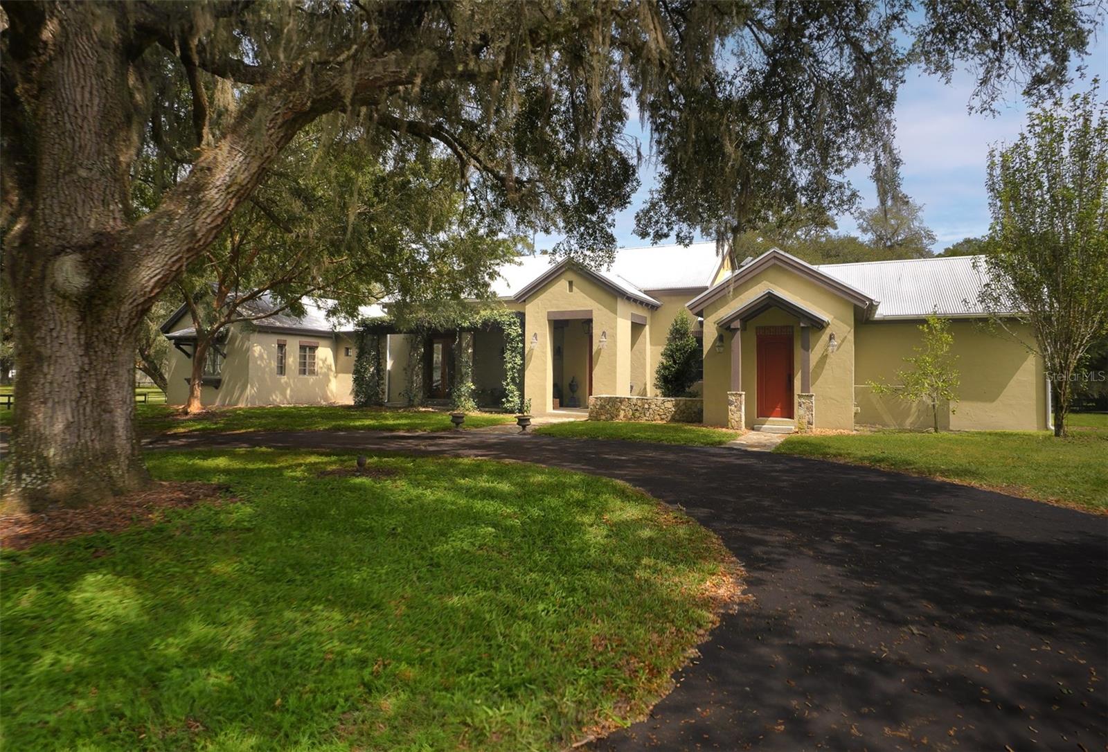 This fantastic 20 acre farm is home to some of the most beautiful pastures, landscapes, and granddaddy oaks in the area. It's 3-boardfenced, and less than 15 minutes to the renowned World Equestrian Center and Golden Ocala Country Club, and less than 3 miles to HITS showgrounds. The custom home features special design elements and master craftsmanship throughout, including wood-beamed ceilings, travertine flooring, spectacular island kitchen with new Thermador appliances and Subzero refrigerator, and a spectacular en suite master bedroom retreat. The master BR has its own patio just outside the double doors; step outside and enjoy the sounds of the birds, and the views of your private and serene paradise. A lovely sunroom has recently been added off the kitchen, providing a wonderful spot to relax and enjoy the outdoor views from the comfort of your home. The barn features 5 stalls, tongue and groove, ceiling fans, flyspray sytem, washrack with hot/cold water, a/c tack room w/washer, dryer, bathroom, and kitchenette. A new septic system has been installed to supply the barn and nearby RV hookup. There are 2 pole barns supplying plenty of room for equipment storage. The farm also provides a 20x60 meter all-weather Longwood arena with ggt footing, sprinklers, and mirrors; there is also a round pen. Also included is an adorable 3 BR/2 BA guest home built with the same quality and standards of the main home; it has new washer and dryer, and new a/c. It's perfect for guests, mother-in-law quarters, or a tenant. A generator provides power to the cottage and barn in those rare cases of a power outage. This farm has it all, is perfect for any discipline, and is completely ready for you and your horses to move in. Additional acreage is available.