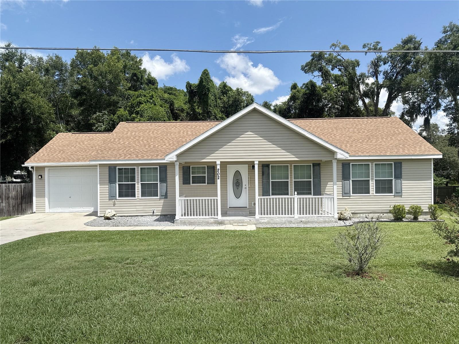 This beautifully renovated 3 bedroom, 2 bath home offers 1,632 square feet of comfortable living space on a generous .38-acre lot, complete with a one-car garage, a fenced backyard for added privacy, and a brand-new roof for peace of mind. Inside, fresh paint, new luxury vinyl plank flooring, and plush carpeting create a move-in-ready feel, blending modern updates with timeless comfort. Perfectly situated in Lady Lake, this home offers the best of both worlds—quiet neighborhood living with quick access to The Villages for world-class golf, dining, shopping, and medical facilities, as well as nearby lakes and outdoor recreation that define Central Florida’s lifestyle. Call for your showing today!