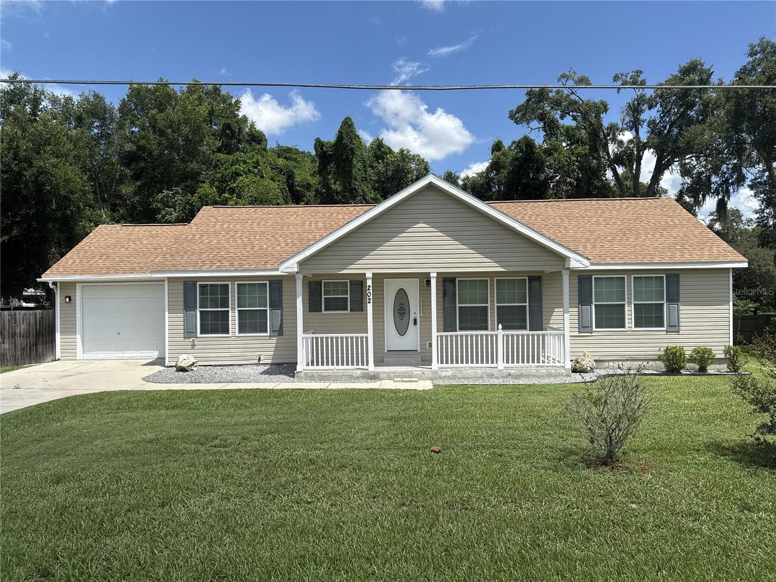 This beautifully renovated 3 bedroom, 2 bath home offers 1,632 square feet of comfortable living space on a generous .38-acre lot, complete with a one-car garage, a fenced backyard for added privacy, and a brand-new roof for peace of mind. Inside, fresh paint, new luxury vinyl plank flooring, and plush carpeting create a move-in-ready feel, blending modern updates with timeless comfort. Perfectly situated in Lady Lake, this home offers the best of both worlds—quiet neighborhood living with quick access to The Villages for world-class golf, dining, shopping, and medical facilities, as well as nearby lakes and outdoor recreation that define Central Florida’s lifestyle. Call for your showing today!