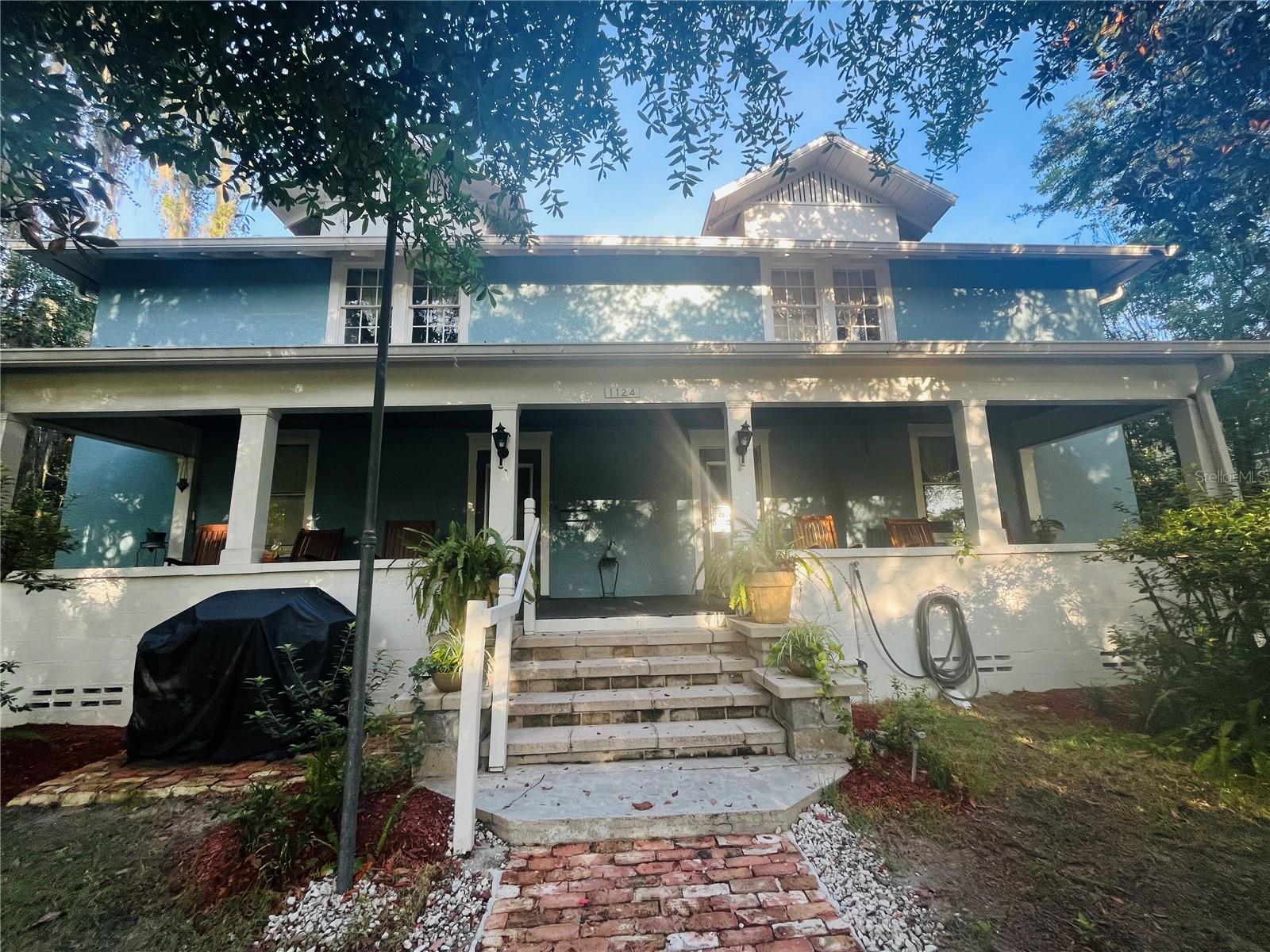 This historic home is located near downtown. Walking distance from Grove Street amenities, enjoy the proximity to a walking/bike trail, gym, C&G Brewery, weekly farmer's market, restaurants, yoga studio, grocery store, and others. Furnished with antiques, this home has the modern comforts of a new kitchen and bathrooms. Downtown is 1 mile away, the University of Florida is 2 miles away, and UF Health Shands Hospital is also 2 miles away.
Rear of the property has a spacious shop and storage area(s). The lot is spacious and .69 of an acre, surrounded by prime development land.