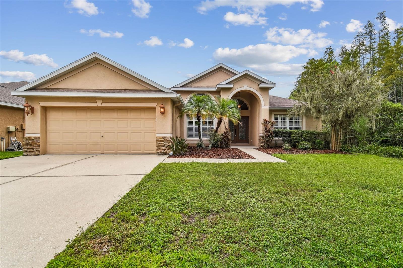 One or more photo(s) has been virtually staged. GATED COMMUNITY!! NEW TAMPA'S FINEST SINGLE FAMILY HOME! Gorgeous move in ready home with a fabulous desired OPEN FLOOR PLAN!! Dressed with gorgeous custom plantation shutters ! HIGH VOLUME ceilings and incredible NATURAL LIGHT ! WINDOWS GALORE!!! Fantastic living room / dining room combo offering SPACIOUS room for entertaining! Gourmet kitchen with updated stainless steel appliances ! CONVECTION OVEN with air fryer built in !! EXTRAS !! EXTRAS !! EXTRAS!! Enormous pantry for plenty of dry goods and a decadent kitchen island! YOUR CATERERS WILL LOVE THE BONUS COUNTER TOP SPACE!!!!!!!! Family room overlooking your private lanai! MORE SPACE for those family movie nights!! Plenty of space for your home theater or big screen! Primary retreat can accommodate a intimate sitting area and a KING SIZE bed and still offer a TON OF LIVING SPACE! Grand primary bathroom with garden tubs ! Stand up shower and double vanity ! ENORMOUS WALK IN closet with CUSTOM built ins! WASHER AND DRYER all convey! YARD SPACE BACK on private conservation NO SIDE NEIGHBOR ... JUST TREES TREES TREES and wild life! Bring your plans for a pool and swing set or just enjoy the MASSIVE yard! Fantastic yard that your pets will love! West Meadows community also has dynamite amenities!! TENNIS COURTS , POOL, PLAYGROUND and CLUBHOUSE! Come tour West Meadows finest!