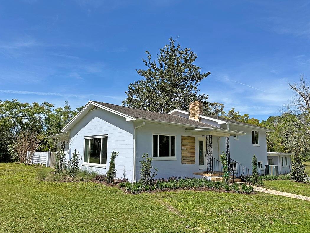 Welcome to your dream home! This beautifully renovated mid-century modern split-level block home is a true gem located in the vibrant heart of Williston. Post office, restaurants, shopping, pharmacy, city hall, park and churches are all within a short walk. As you step inside, you'll be greeted by a spacious living room featuring a cozy fireplace, perfect for relaxing evenings. The living area seamlessly flows into the dining area and a stunningly renovated kitchen, making it an ideal space for entertaining family and friends. The original wood floors add warmth and character throughout the main living spaces, enhancing the home's timeless appeal. The upper level accessed by a short stair case, features two comfortable bedrooms and two baths, ensuring privacy and convenience for you and your guests. One of the standout features of this home is the bright and sunny Florida room, where you can bask in natural light while overlooking your secluded courtyard—an oasis for outdoor relaxation or gardening enthusiasts. This room has windows on three sides!!! The huge basement offers endless possibilities, complete with a laundry area and a convenient walkout to the carport. The basement is large enough to even enclose some of the space for additional rooms. Just a few steps from the basement, this home features an additional bedroom and bath in a separate apartment, perfect for guests, in-laws, or as a potential rental opportunity. Meticulously renovated, the updates preserve the home's mid-century details while incorporating modern comforts. You'll appreciate the brand-new windows, roof, HVAC system, electrical, and plumbing—providing peace of mind and energy efficiency for years to come. Don't miss your chance to own this exceptional MCM home with character and charm in a prime location. Schedule your private tour today and experience the perfect blend of vintage elegance and contemporary living! Two adjacent lots that are possible available but not part of this listing; not sold separately.