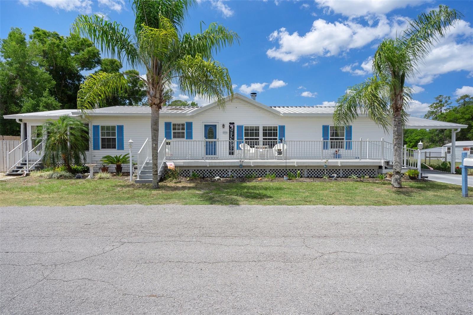 This beautifully maintained 3-bedroom, 2.5-bath manufactured home in serene Brooksville is your chance to Find Your Paradise in a setting that combines comfort, convenience, and room to thrive. Freshly painted and thoughtfully updated, this home--with a metal roof over for longevity and peace of mind AND a NEW HVAC system (2025)--invites you in with new laminate flooring in kitchen and living room and new vinyl in bathrooms, adding both style and durability. The kitchen features brand-new stainless steel appliances and a new ceiling fan, making it the perfect hub for meals and memories, and the living room boasts a wood-burning fireplace for ambiance on cool fall days and warmth on cold winter ones. Enjoy a range of recent updates designed for peace of mind and elevated living: New toilet in the half bathroom New faucets and drains throughout Water Heater - 2022 New back deck, perfect for outdoor entertaining or quiet mornings New side garage door Step outside to enjoy a fenced backyard—ideal for pets, play, or gardening. A detached garage offers great storage or workshop potential, and the 240-amp hookup in the carport supports RVs, electric vehicles, or high-powered tools. With space to spread out and upgrades that matter, this property is more than just a house—it's a place to live your best Florida life. 20334 Woodside Street is waiting for you. Schedule your private tour today and start living your paradise.