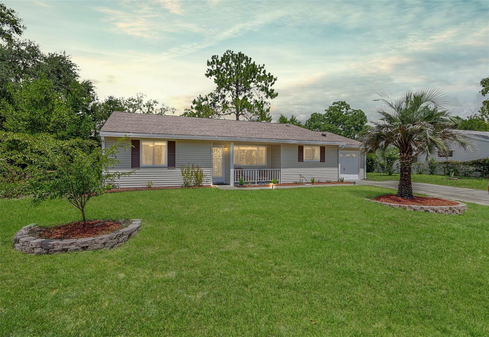 Experience easy and affordable Florida living in this turn-key 3-bedroom, 2-bath home located in the gated, 55+ Oak Run golf course community. Designed for both comfort and style, the home features a flexible open floor plan and a fresh roof installed in 2020 for added peace of mind. Located near one of several community pools, it also offers the perfect blend of privacy and convenience. A welcoming front porch welcomes you into the light and bright living area, highlighted by high ceilings, a neutral color palette, and tile floors throughout for ease of maintenance. Sliding glass doors open onto a screened Florida room—ideal for morning coffee or hosting outdoor gatherings with a tranquil view of the tree-lined backyard. The spacious kitchen offers generous cabinetry, a tiled backsplash, white appliances, and a cozy breakfast nook for casual meals. Retreat to the owners’ suite with its spacious layout, including an ensuite bath featuring a vanity area and separate shower room/water closet, and expansive sliders providing direct access to the Florida room. Two nicely-sized guest rooms offer the perfect opportunity to host friends and family or create dedicated spaces for hobbies, reading, or a home office. The attached garage includes a laundry area and a spacious utility room, ideal for added storage and seasonal organization. The Oak Run community offers a vibrant lifestyle and a wealth of amenities, including an 18-hole golf course, fitness center, tennis courts, multiple pools, and a vast selection of clubs and social activities. Whether you enjoy casual outings or fine dining, you’ll find plenty of options in and around the community. Its prime location also provides easy access to shopping, medical facilities, parks, and more. Come see this home today—it’s ready to welcome you to your new, relaxed Florida lifestyle. This isn’t just a house—it’s the lifestyle you deserve.